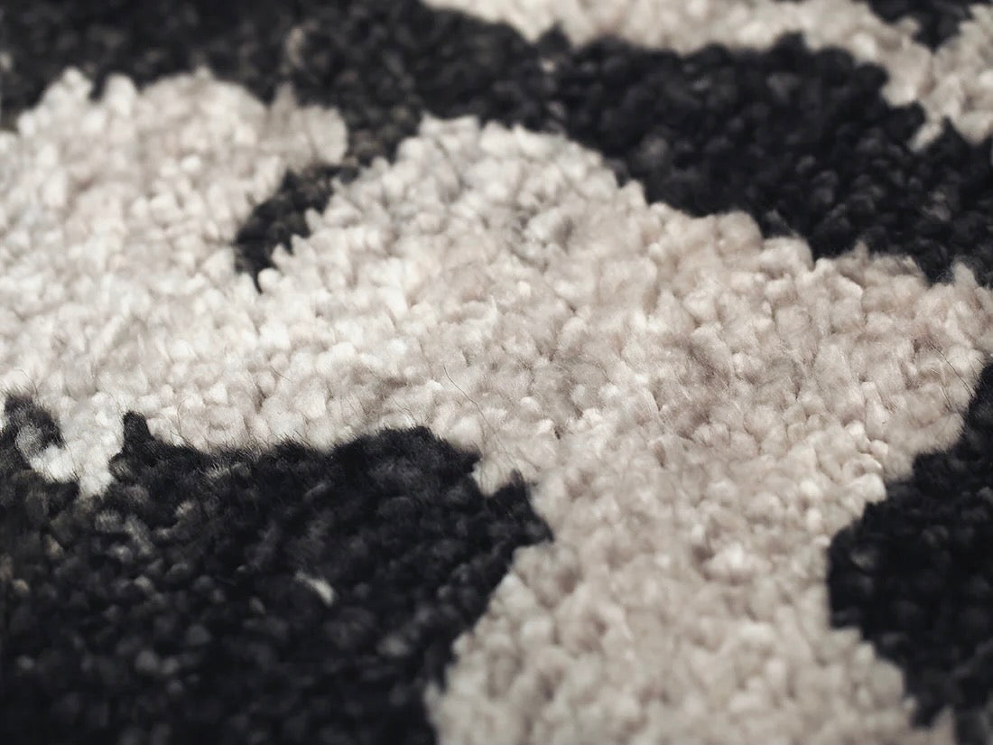 oriental rug with an abstract traditional pattern in grey