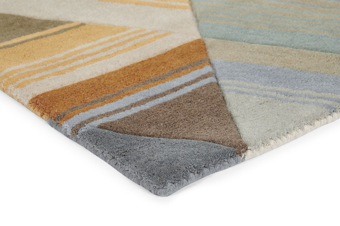 Harlequin rug with a multi-directional stripe design in grey and mustard yellow
