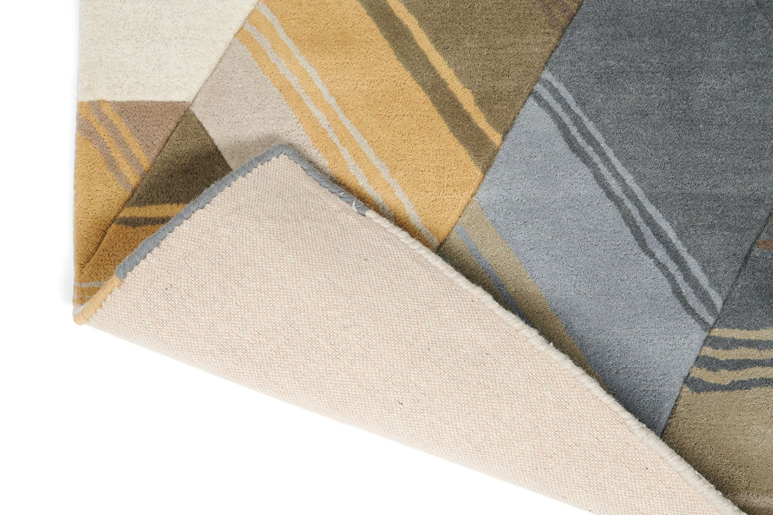 Harlequin rug with a multi-directional stripe design in grey and mustard yellow