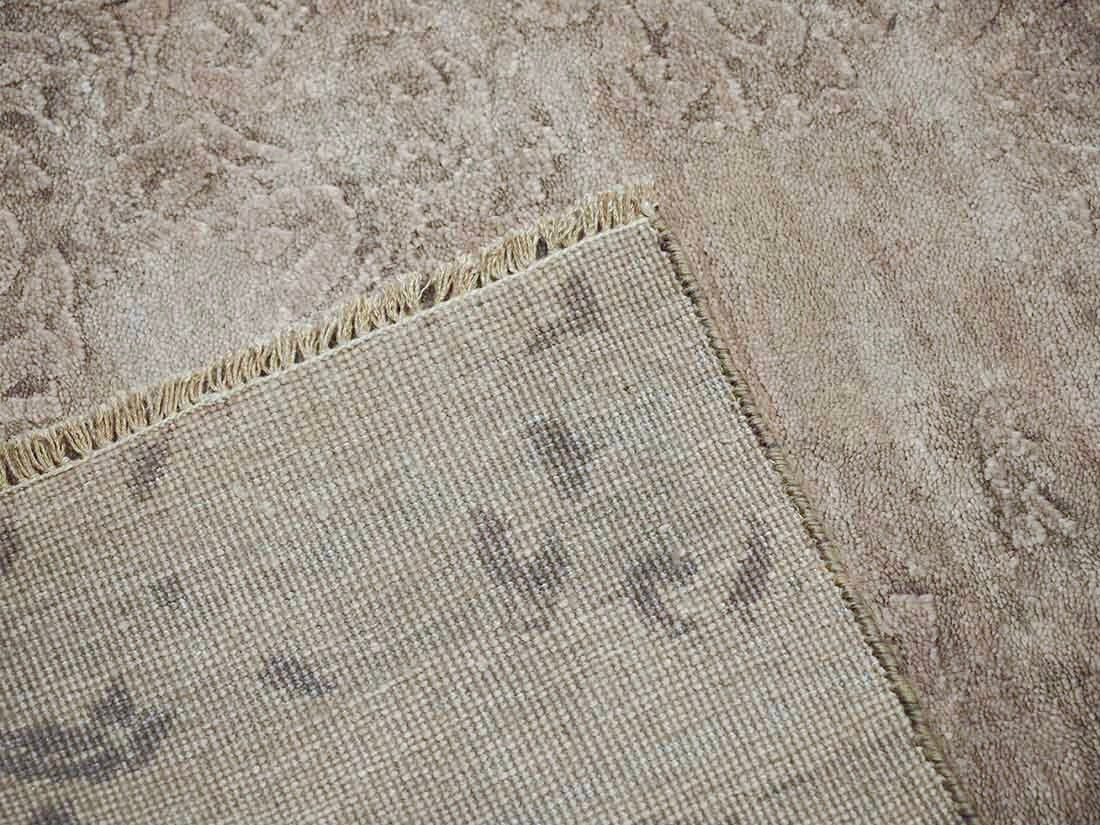Authentic oriental rug with a damask pattern in beige