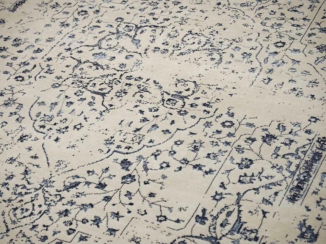 cream and blue oriental rug with a floral design