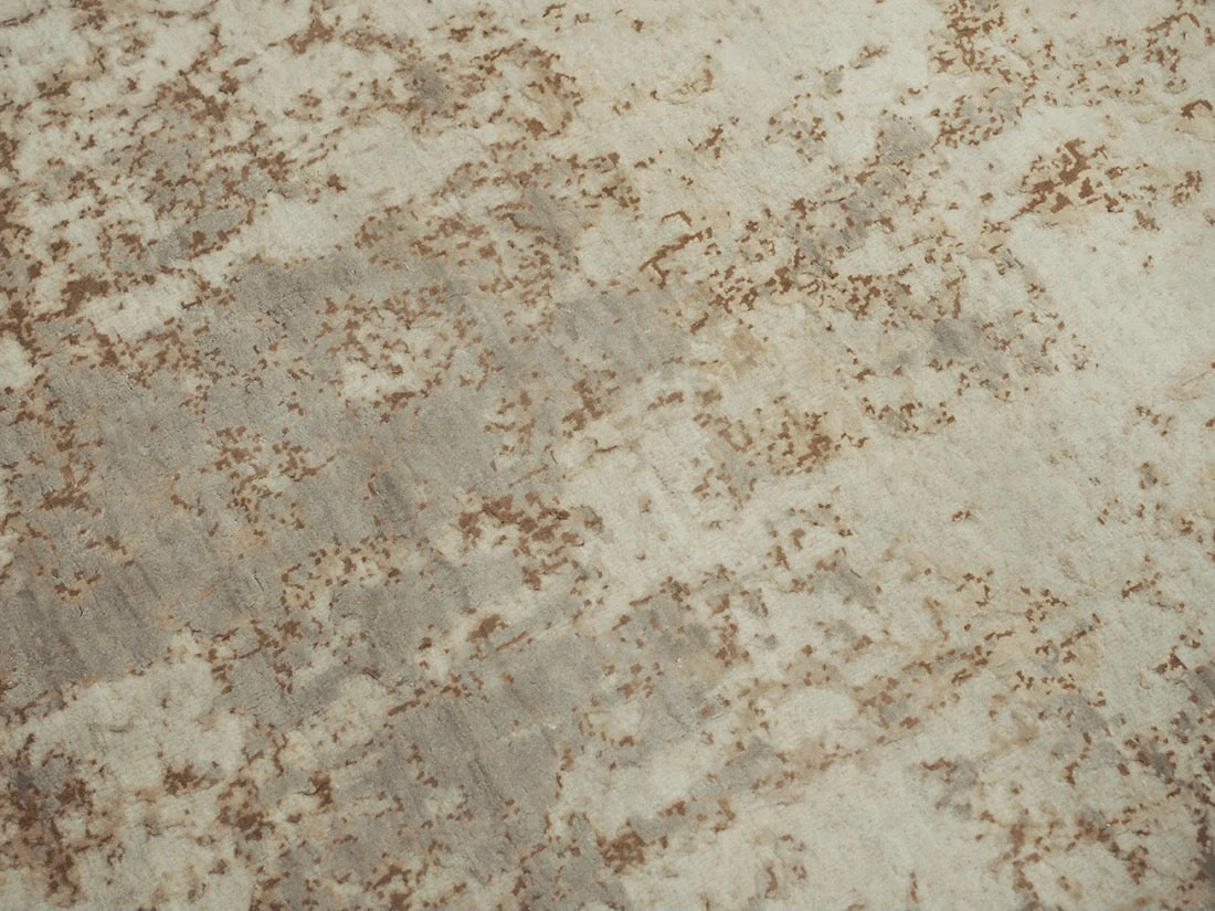 grey and taupe rug with an abstract damask pattern