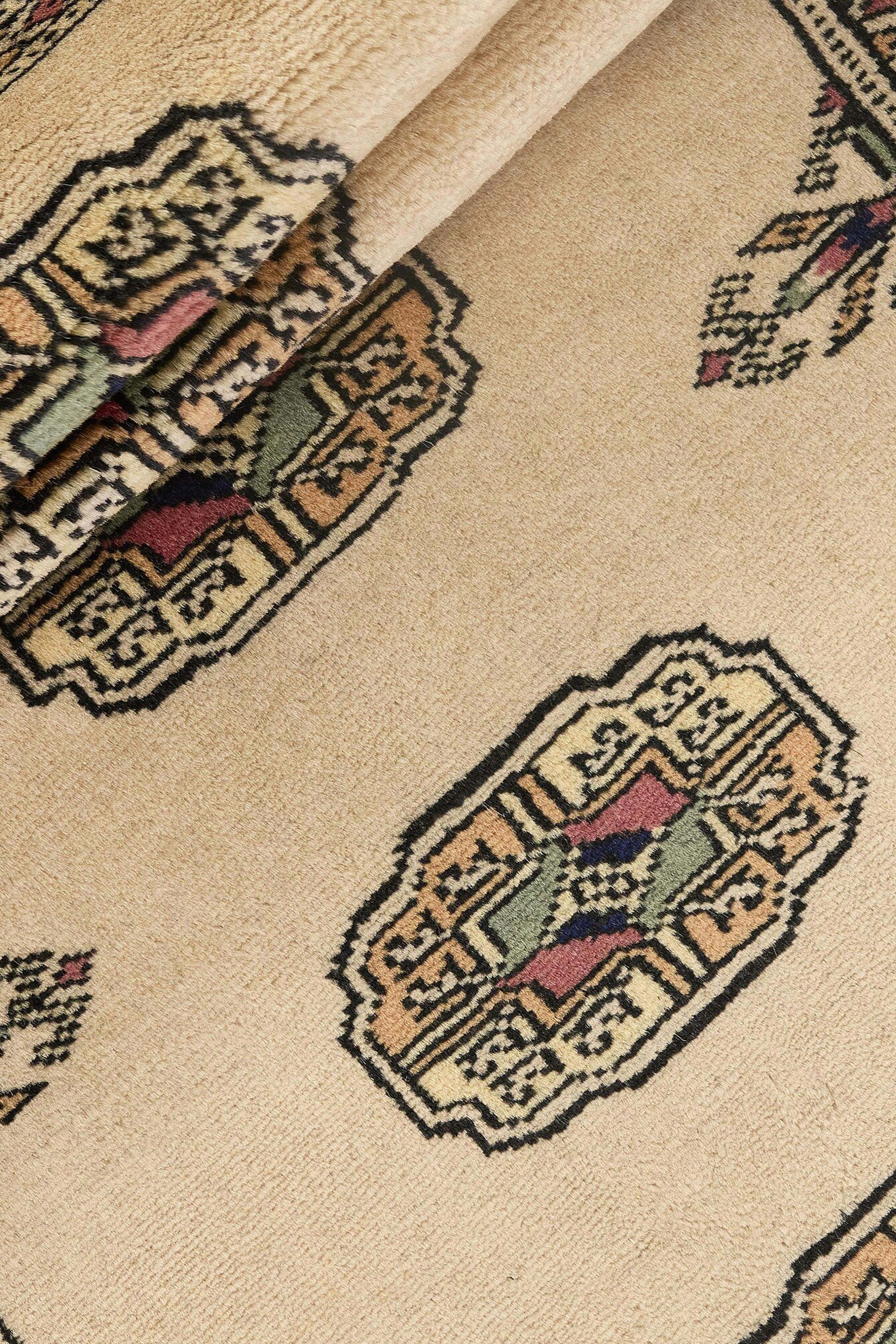Beige Oriental runner with traditional bordered pattern