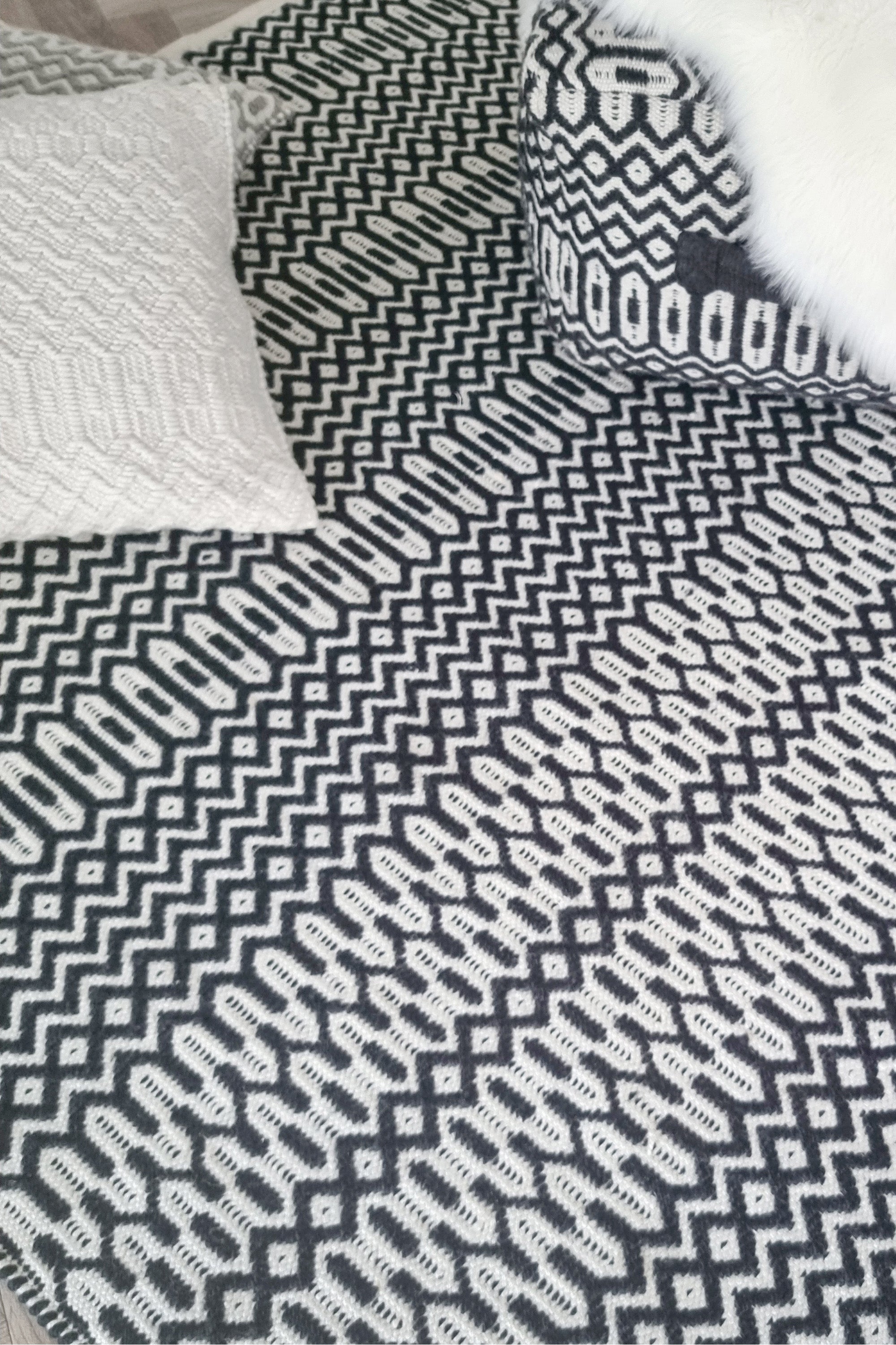 black indoor/outdoor rug with geometric design