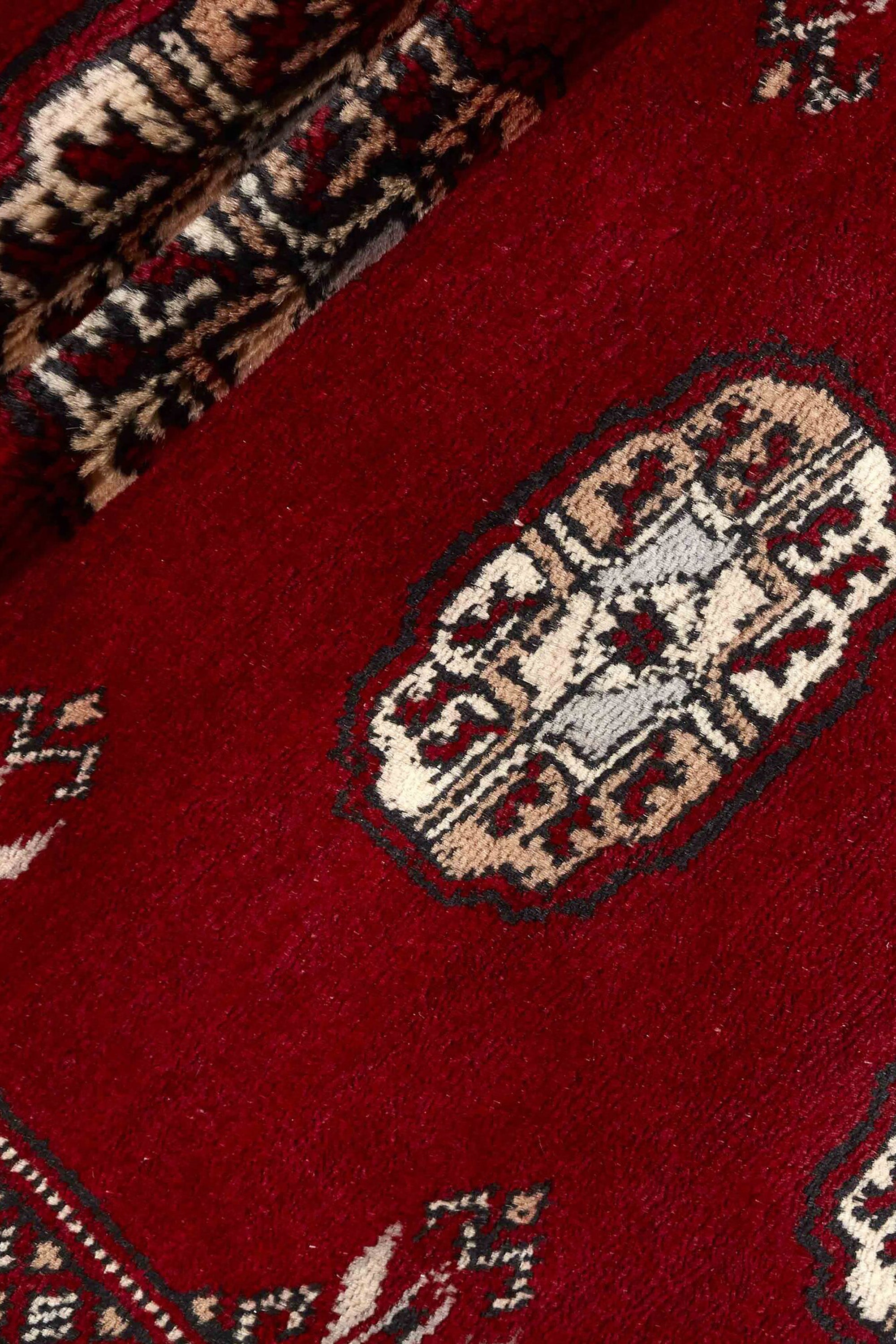 Red Oriental runner with traditional bordered pattern