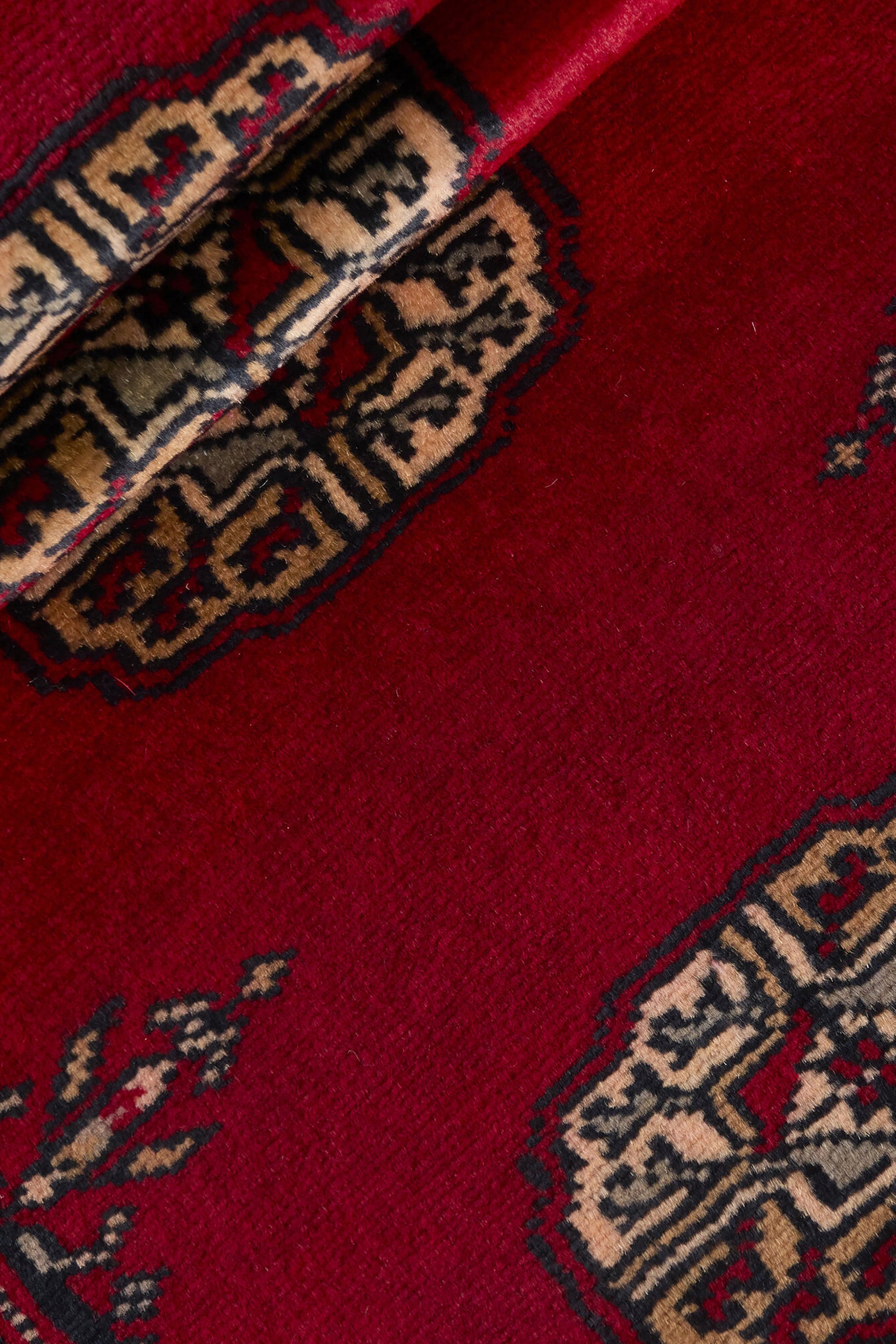 Red Oriental runner with traditional bordered pattern