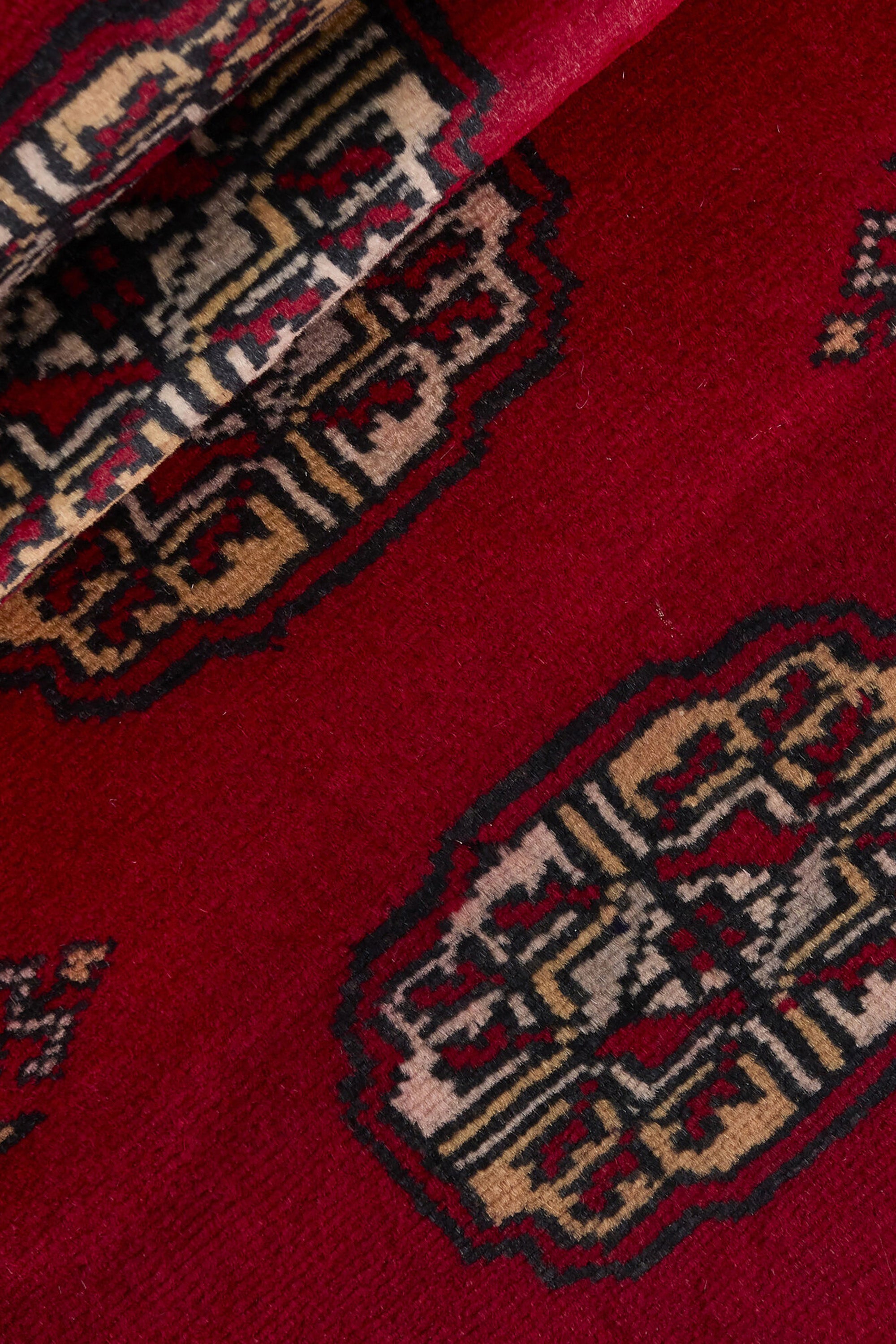 Red Oriental runner with traditional bordered pattern