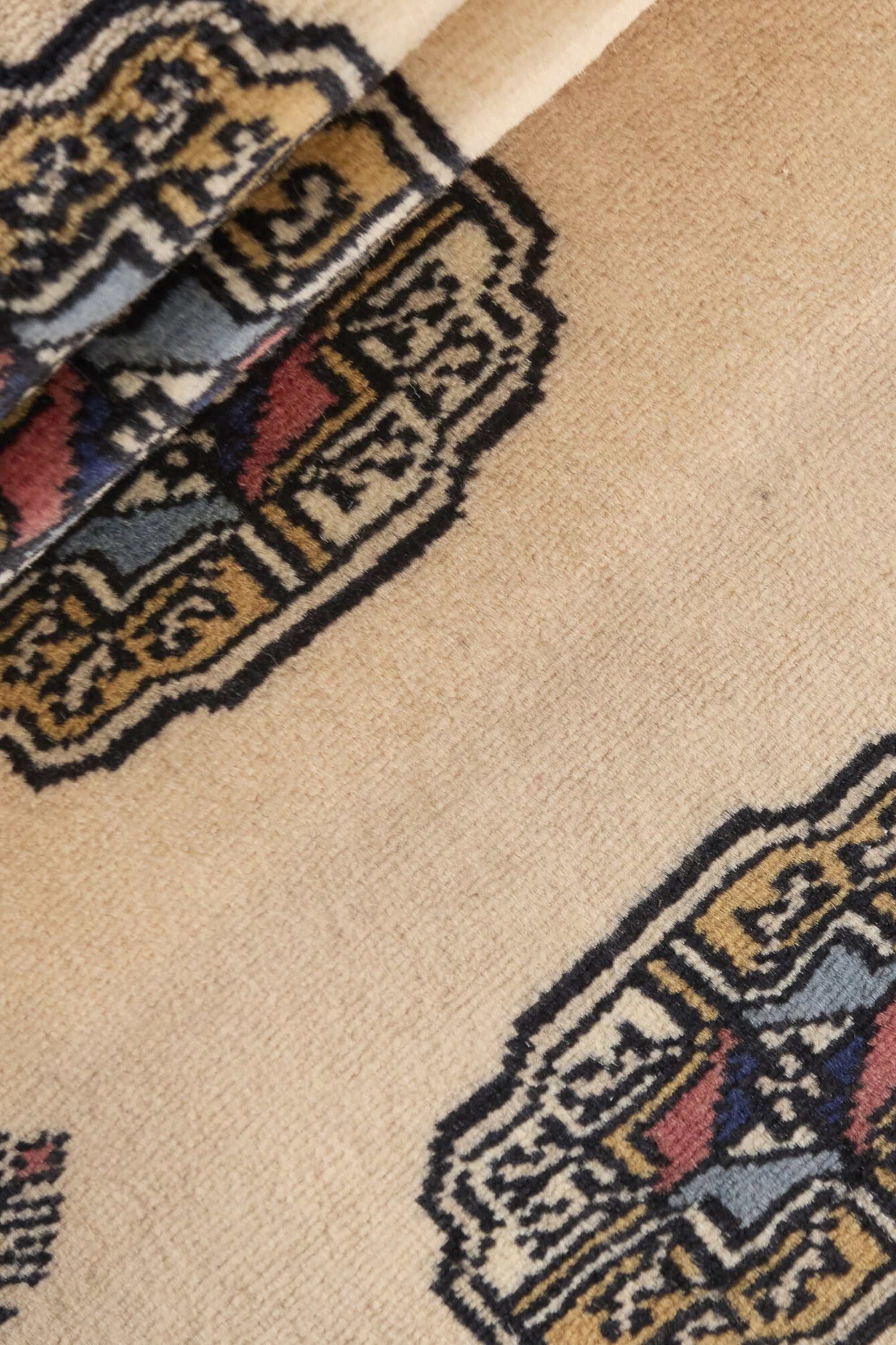 Beige Oriental runner with traditional bordered pattern