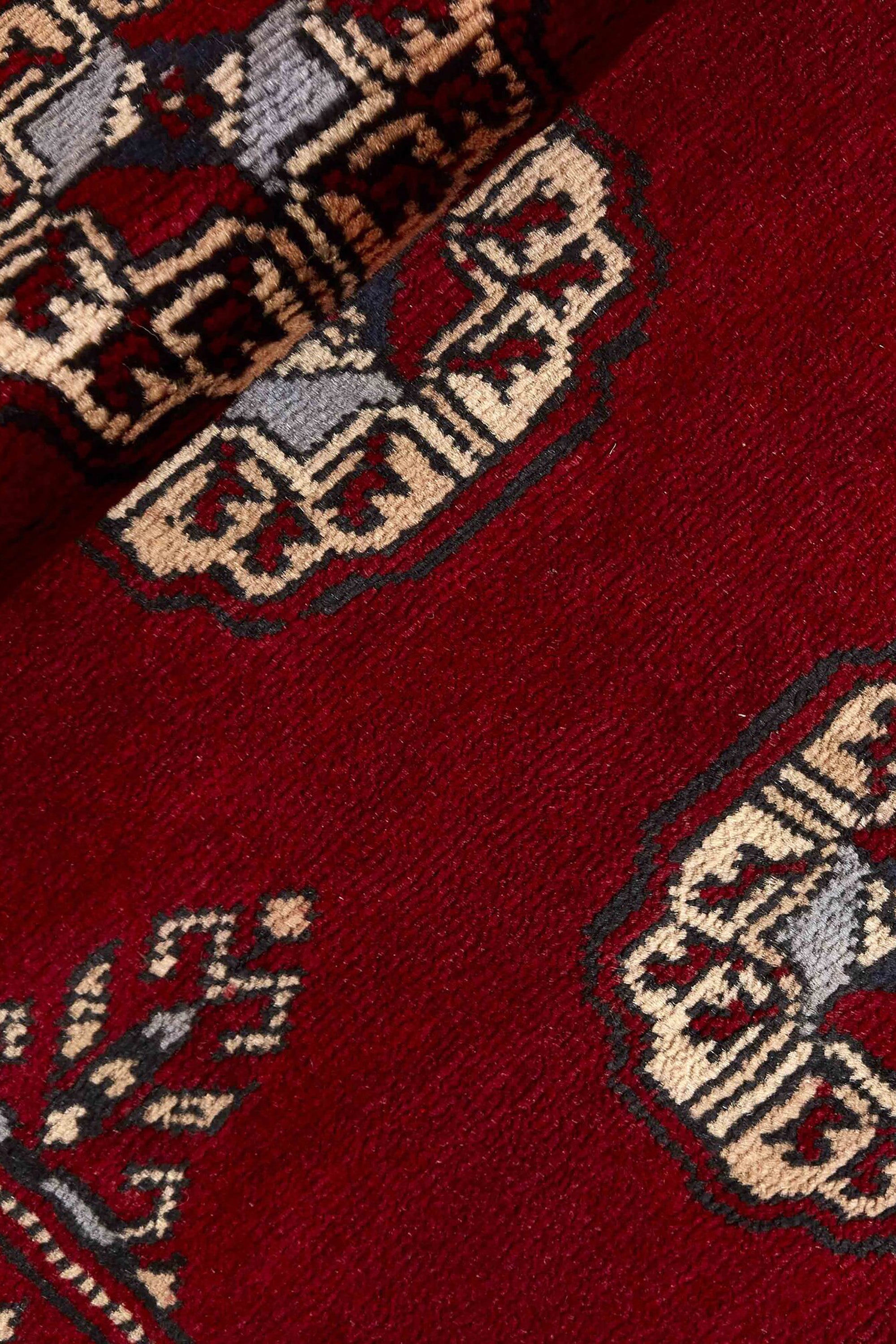 Red Oriental runner with traditional bordered pattern
