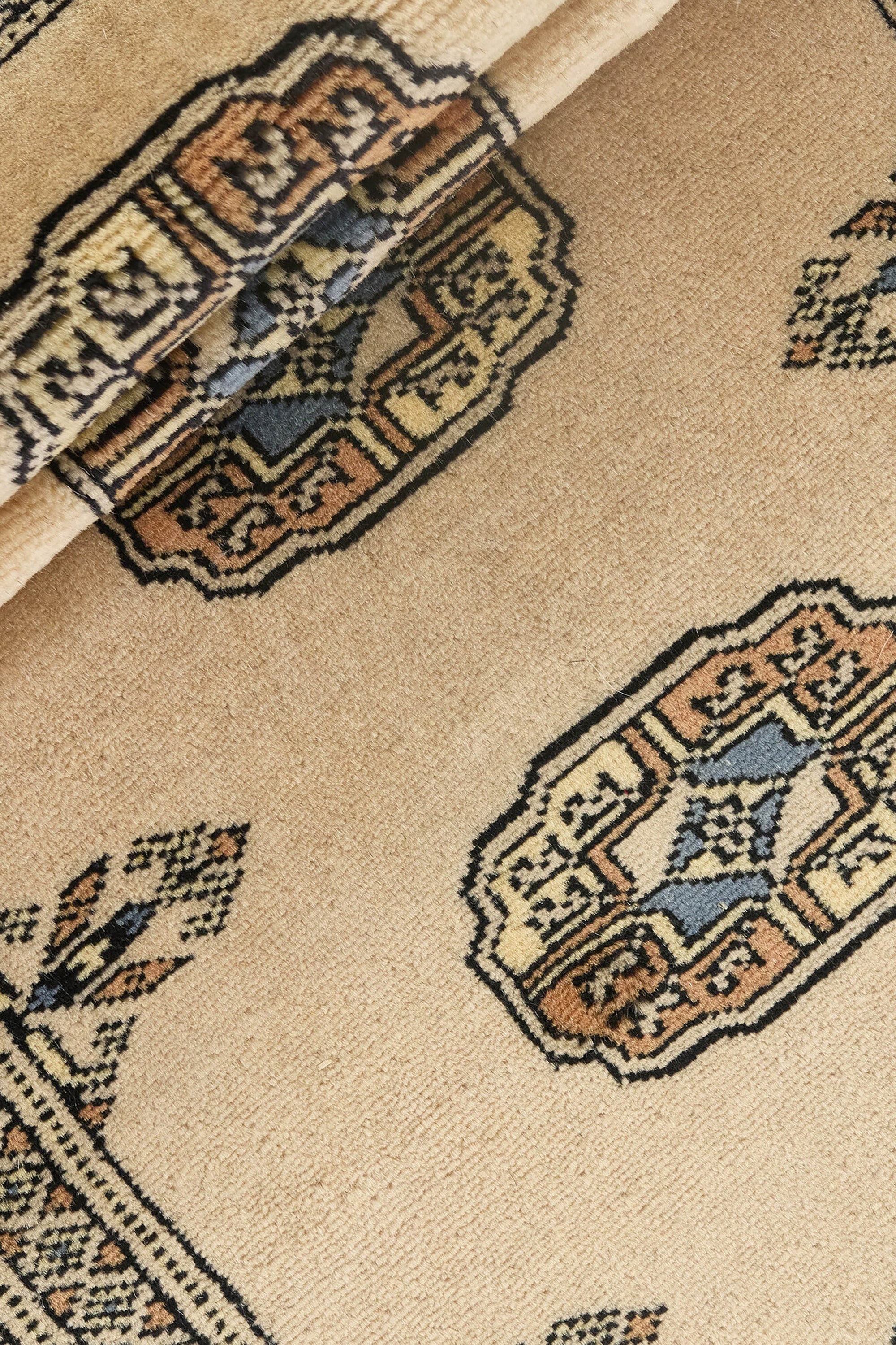 Beige Oriental runner with traditional bordered pattern