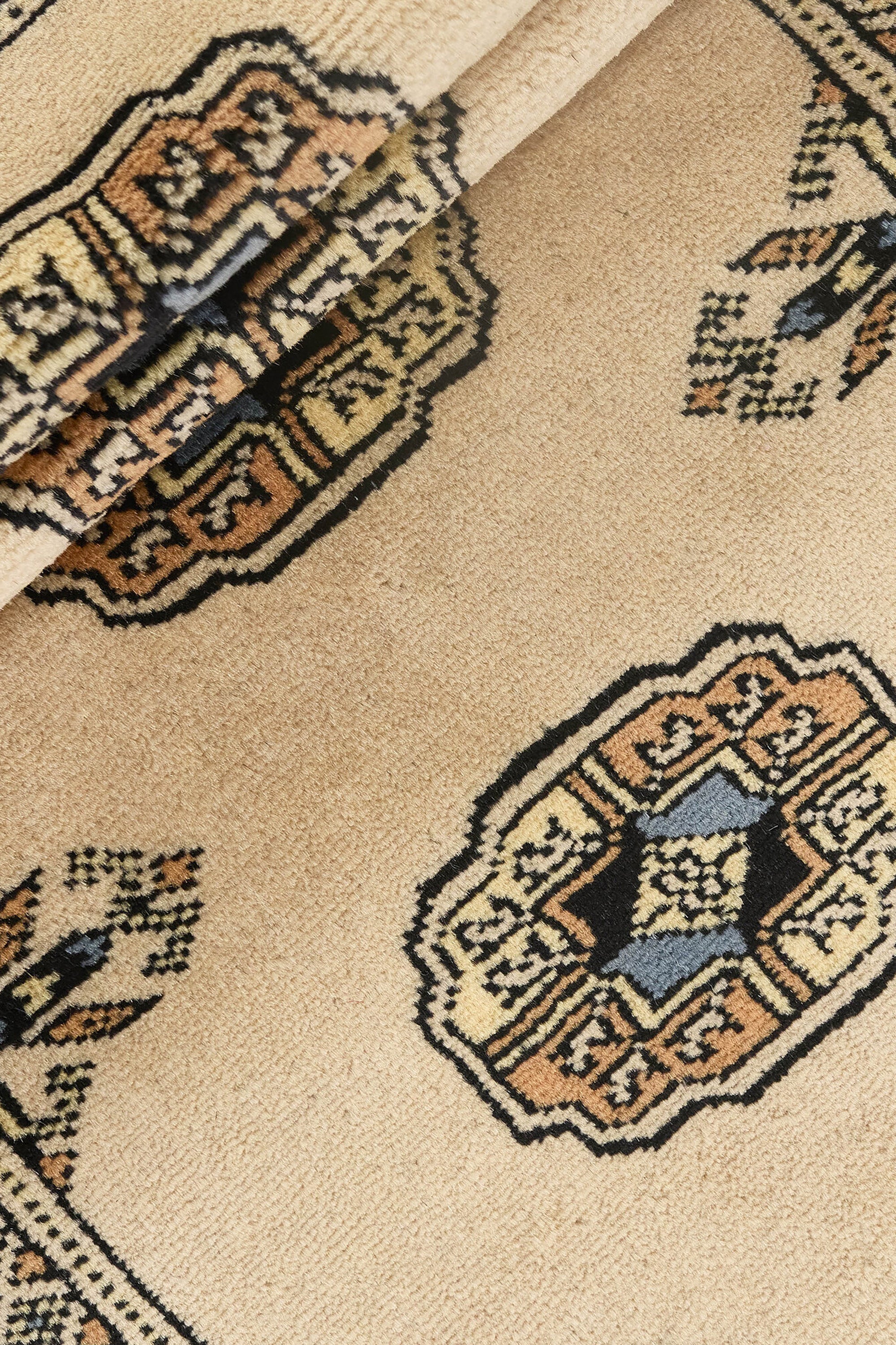Beige Oriental runner with traditional bordered pattern
