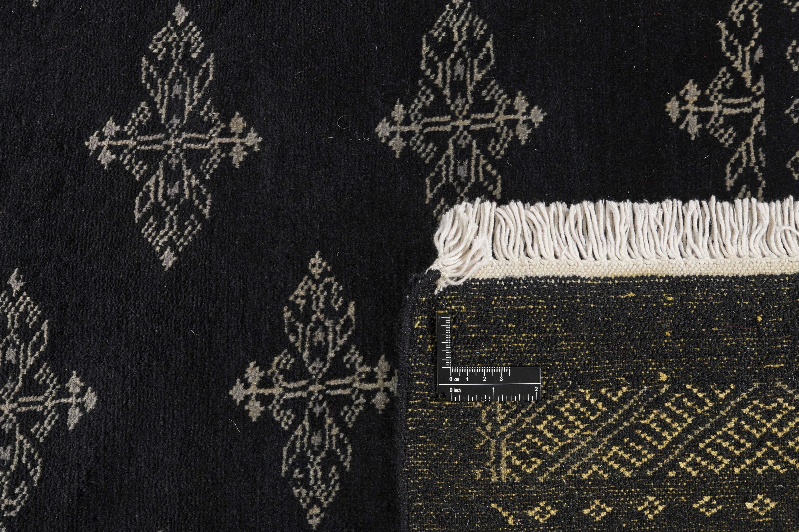 Black Oriental rug with traditional bordered pattern