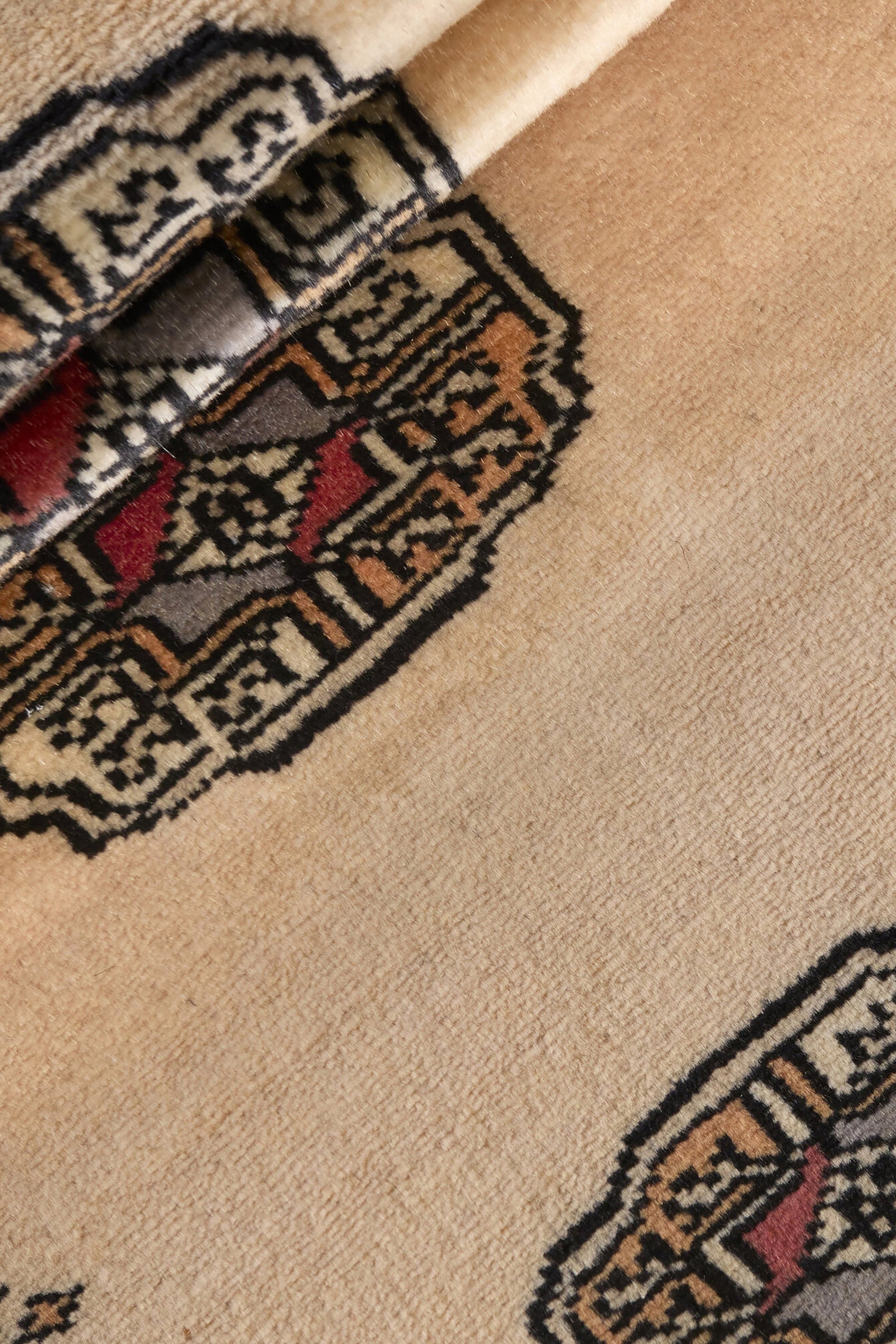 Beige Oriental runner with traditional bordered pattern