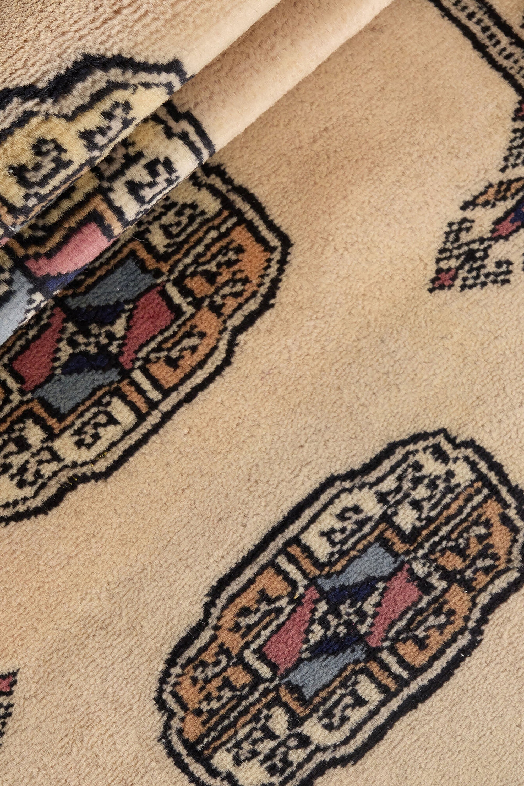 Beige Oriental runner with traditional bordered pattern