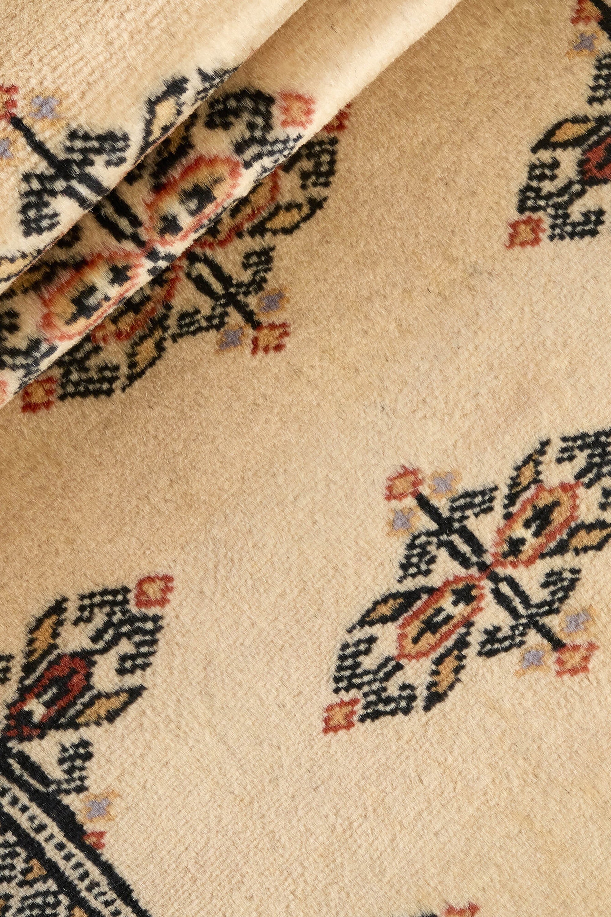 Beige Oriental runner with traditional bordered pattern
