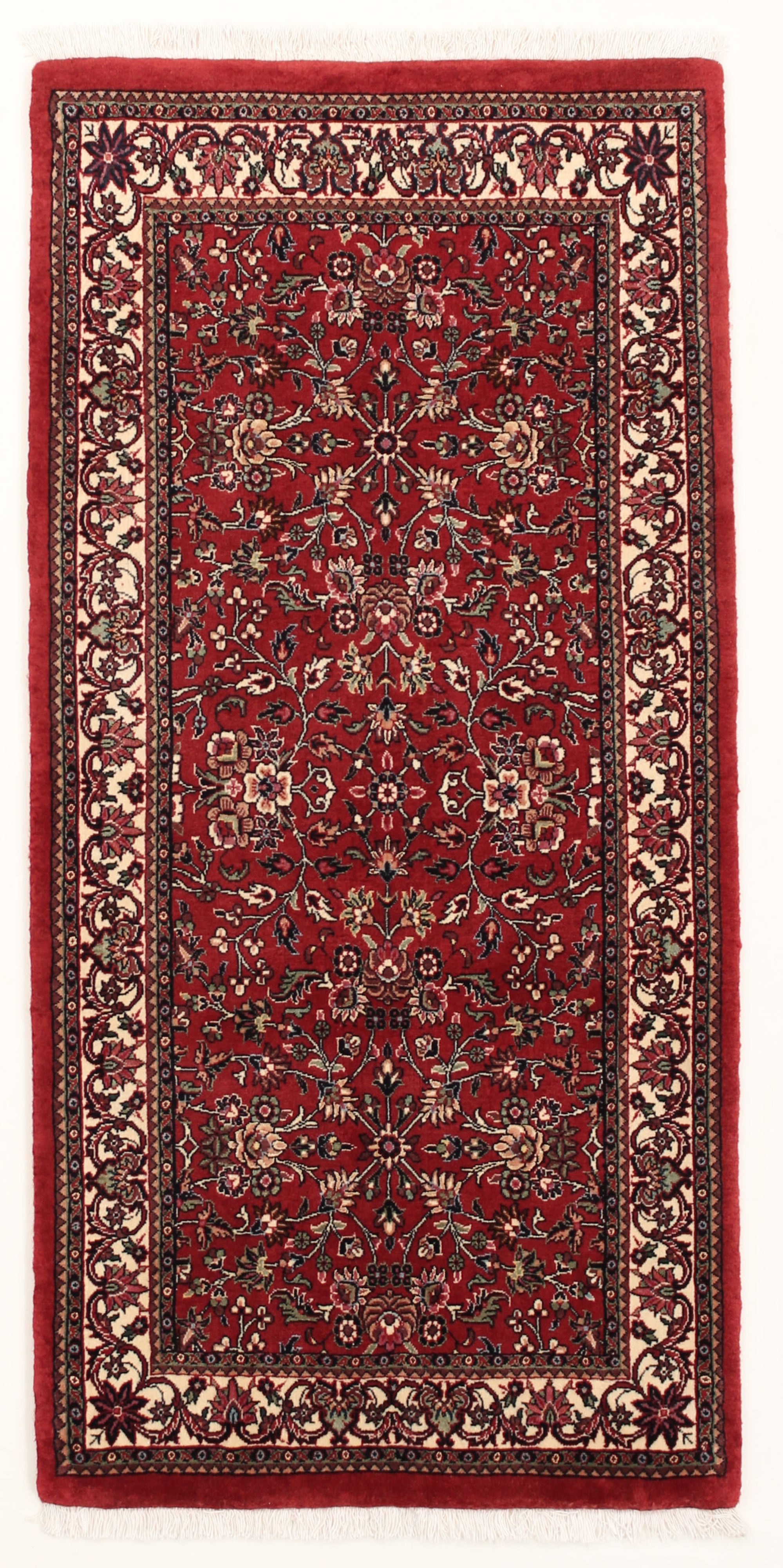 Red and cream persian rug with traditional floral design