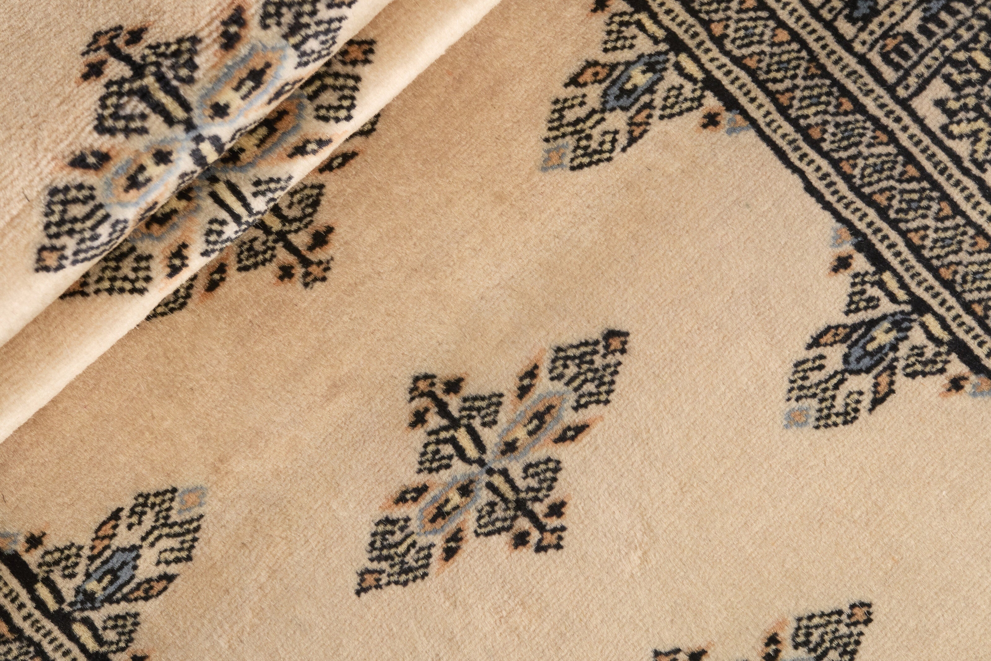 Beige Oriental runner with traditional bordered pattern