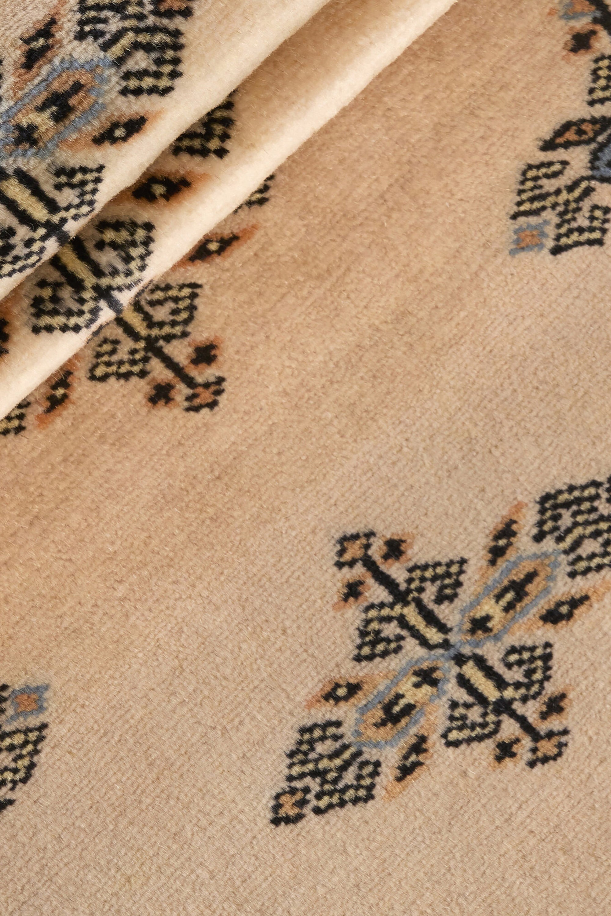 Beige Oriental runner with traditional bordered pattern