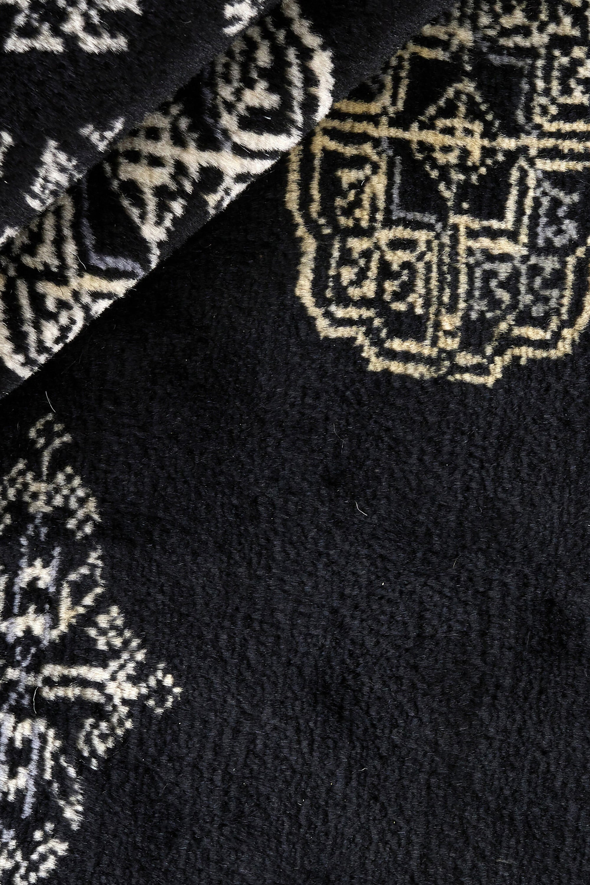Black Oriental rug with traditional bordered pattern
