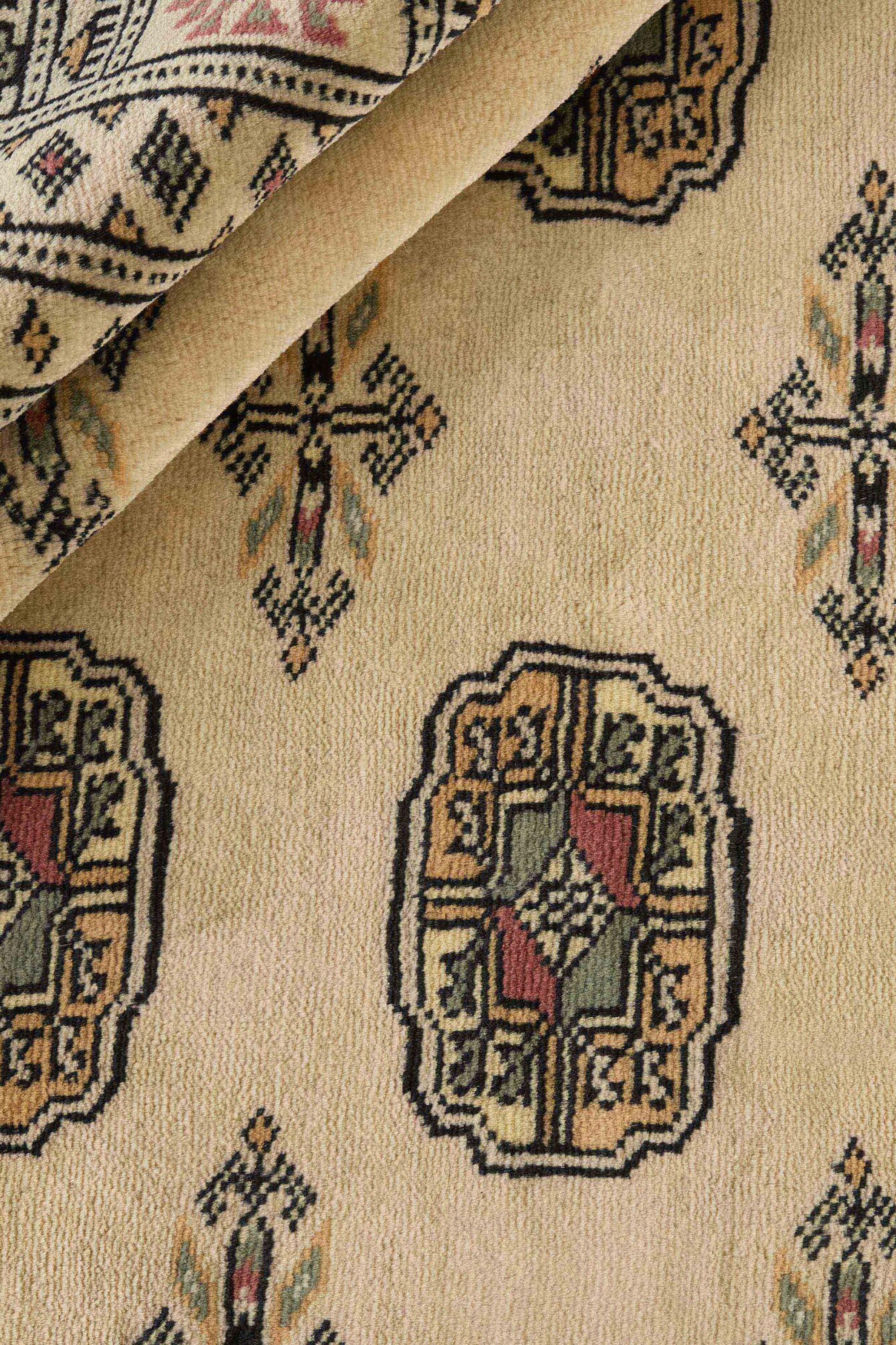 Beige Oriental rug with traditional bordered pattern
