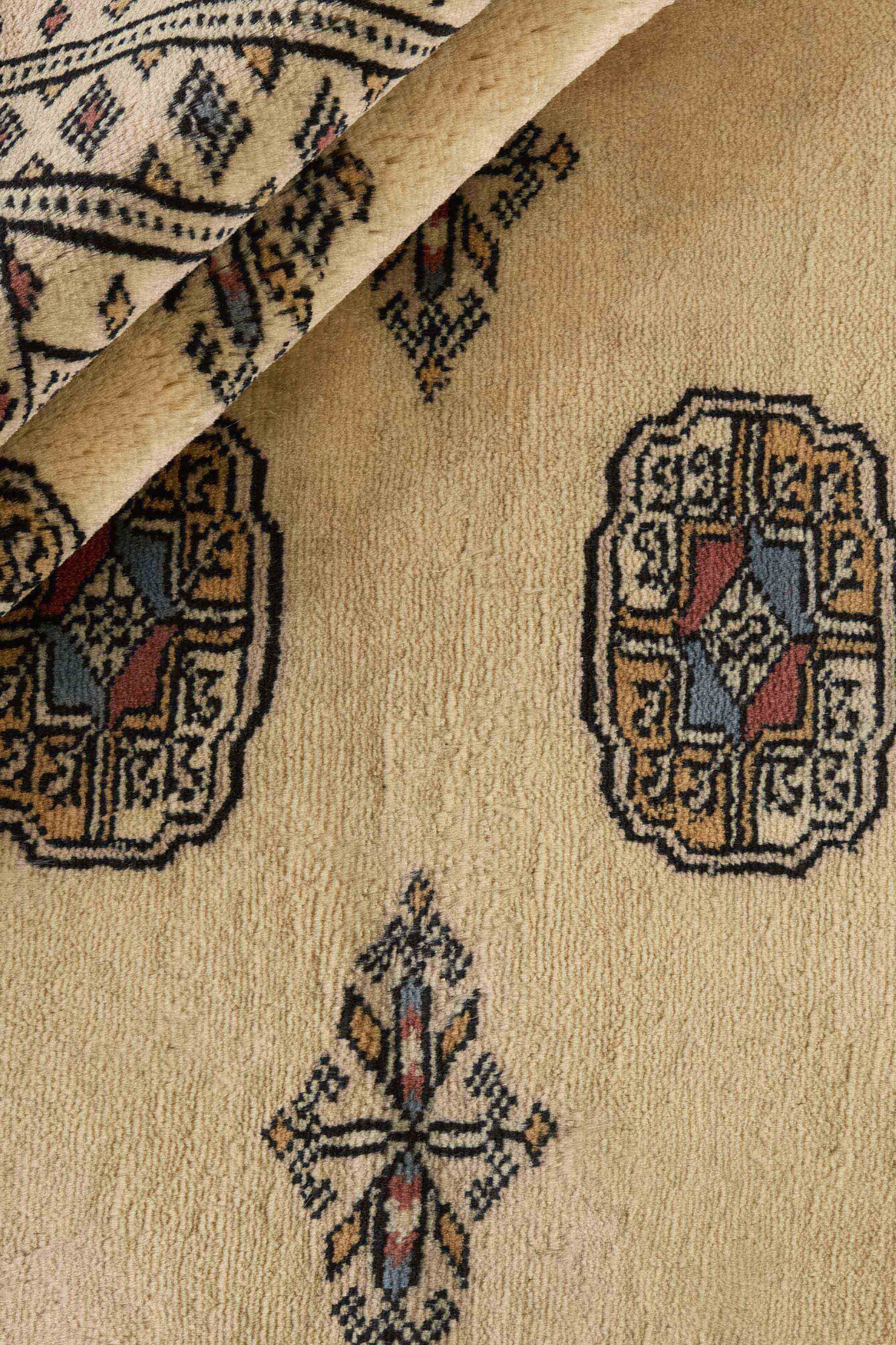 Beige Oriental rug with traditional bordered pattern
