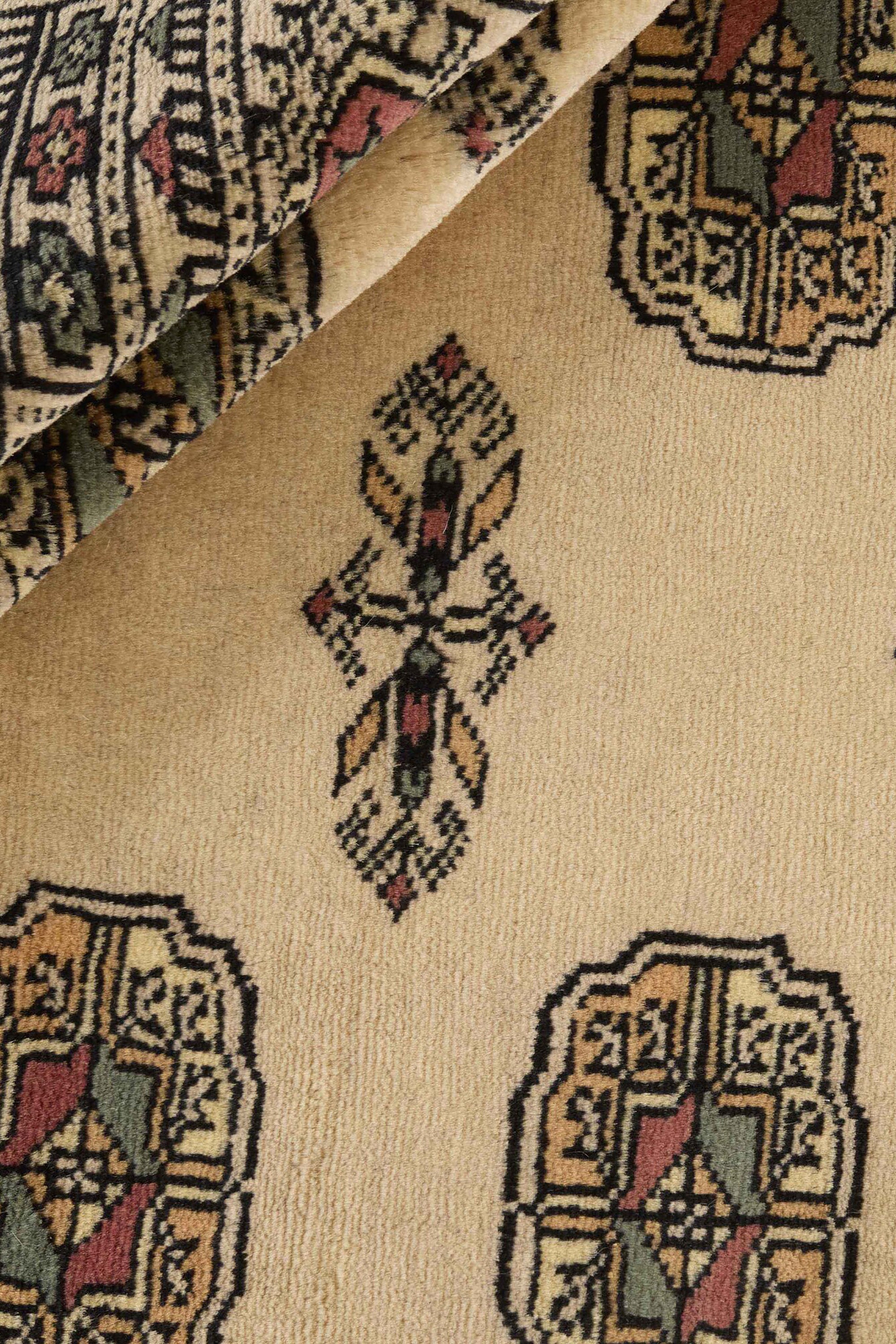 Beige Oriental rug with traditional bordered pattern