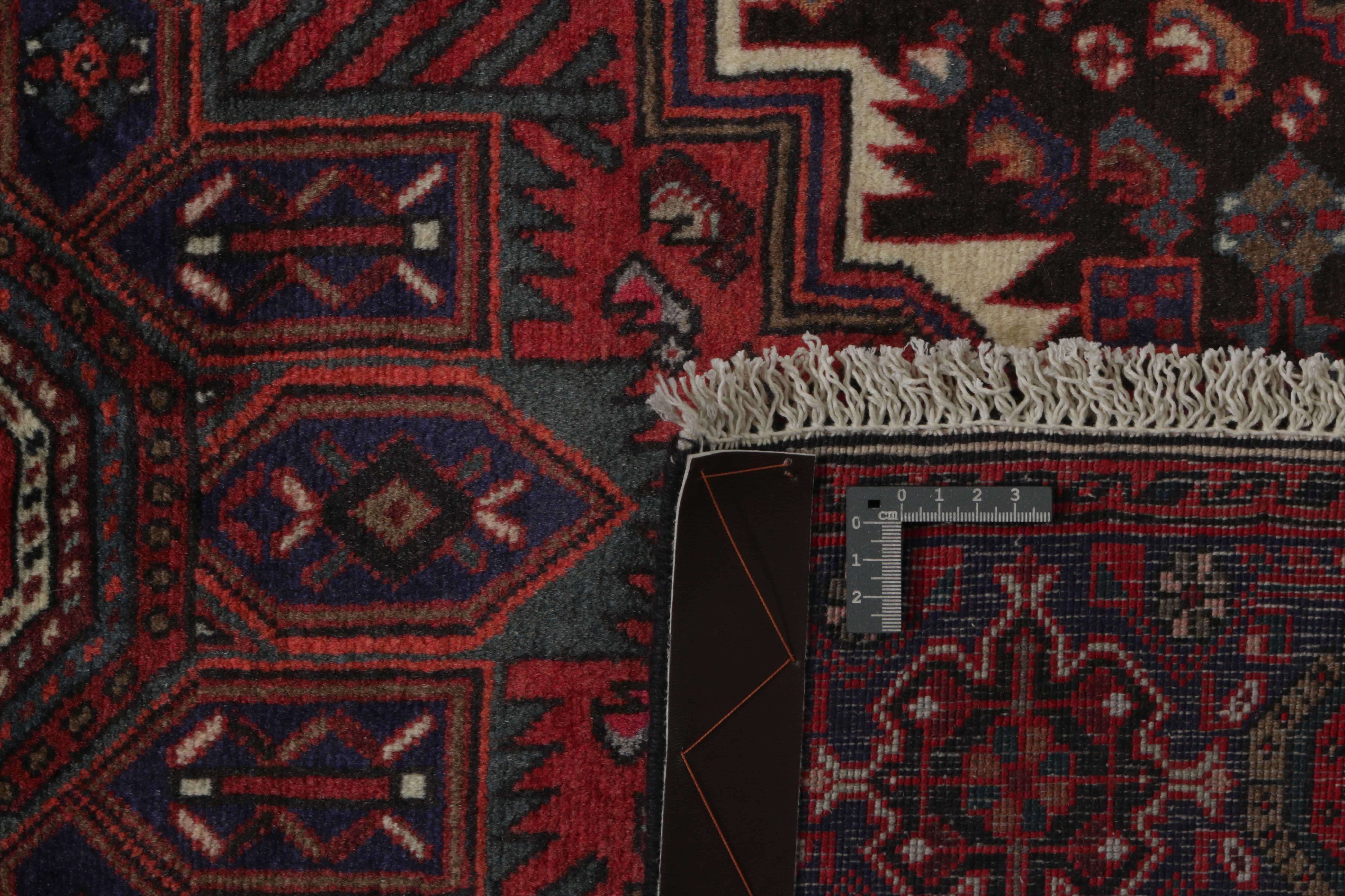 Red and beige persian rug with a floral design