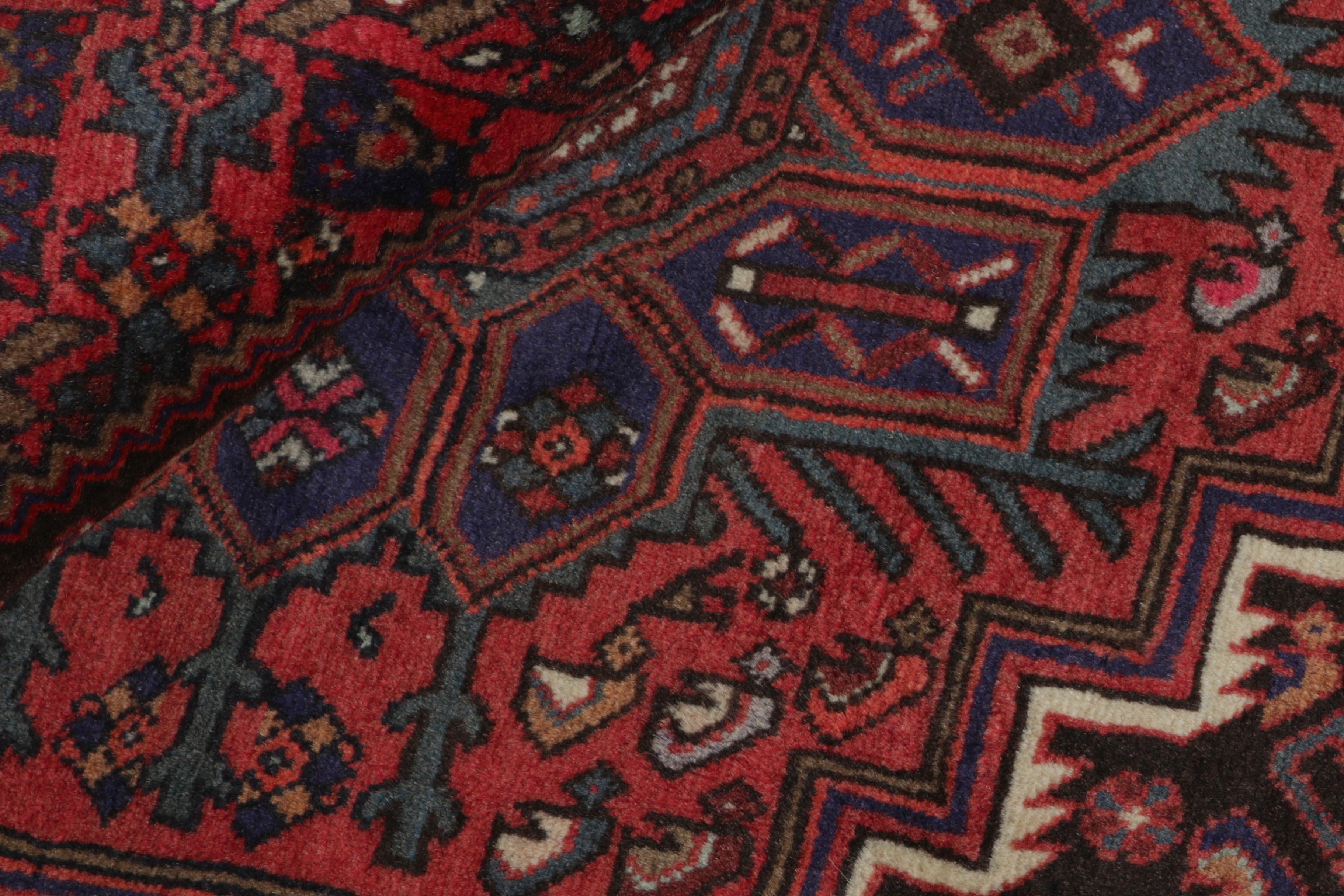 Red and beige persian rug with a floral design