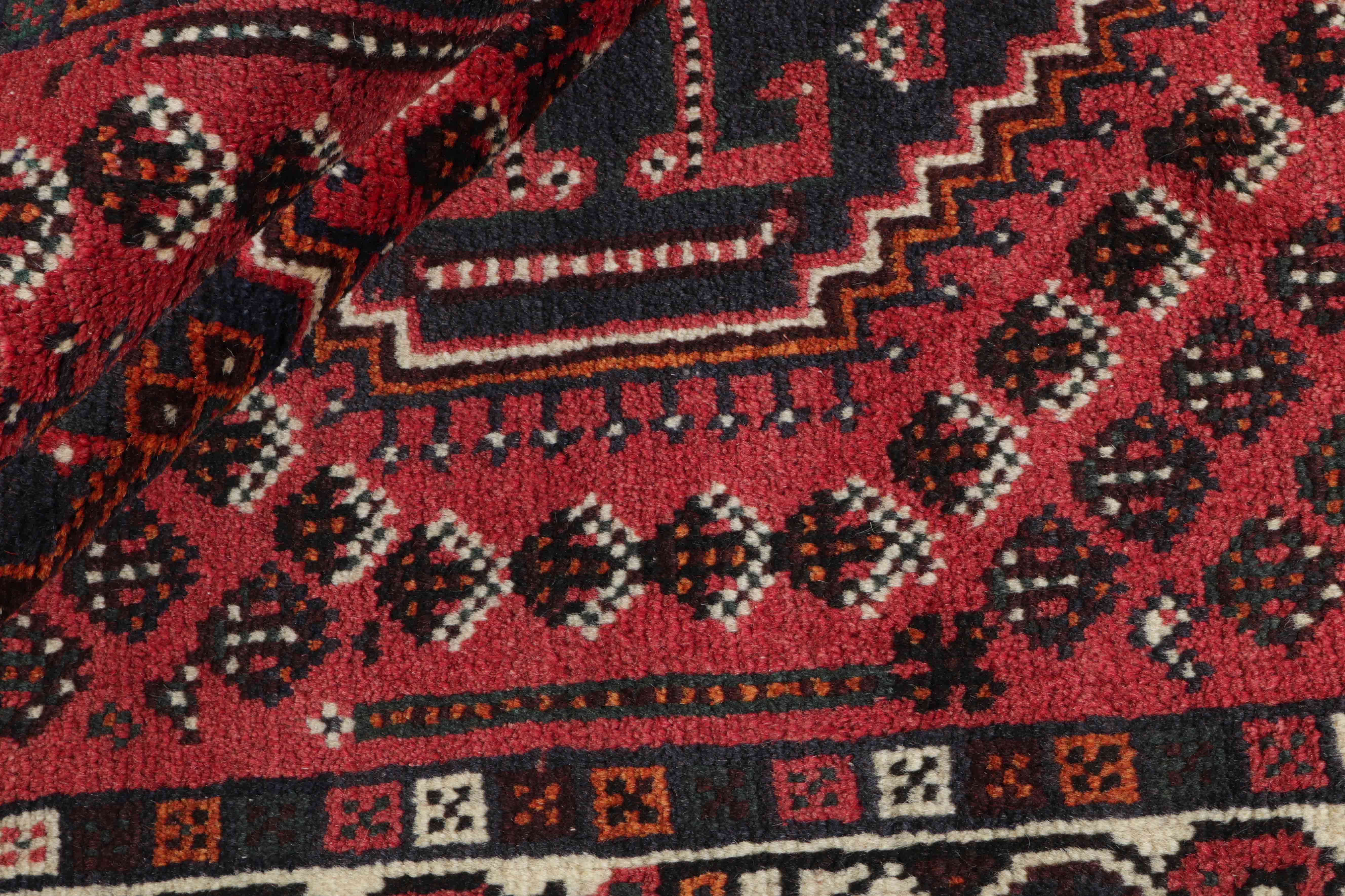 Authentic persian rug with a traditional tribal geometric pattern in red