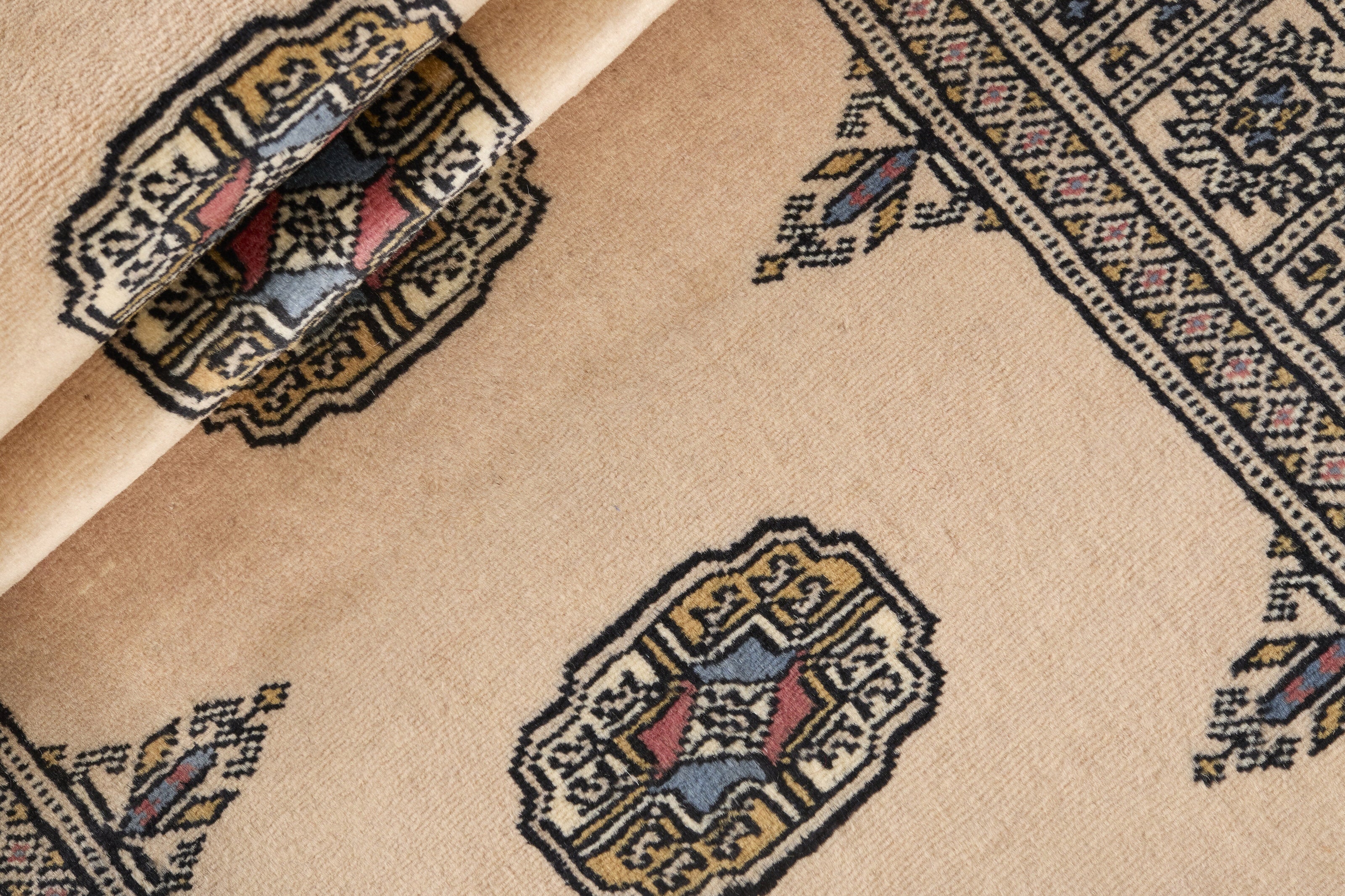 Beige Oriental runner with traditional bordered pattern