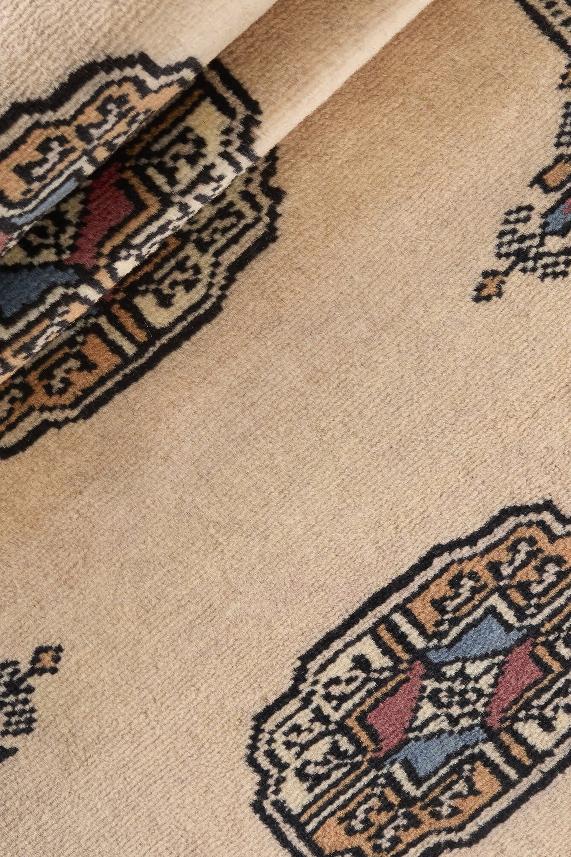 Beige Oriental runner with traditional bordered pattern