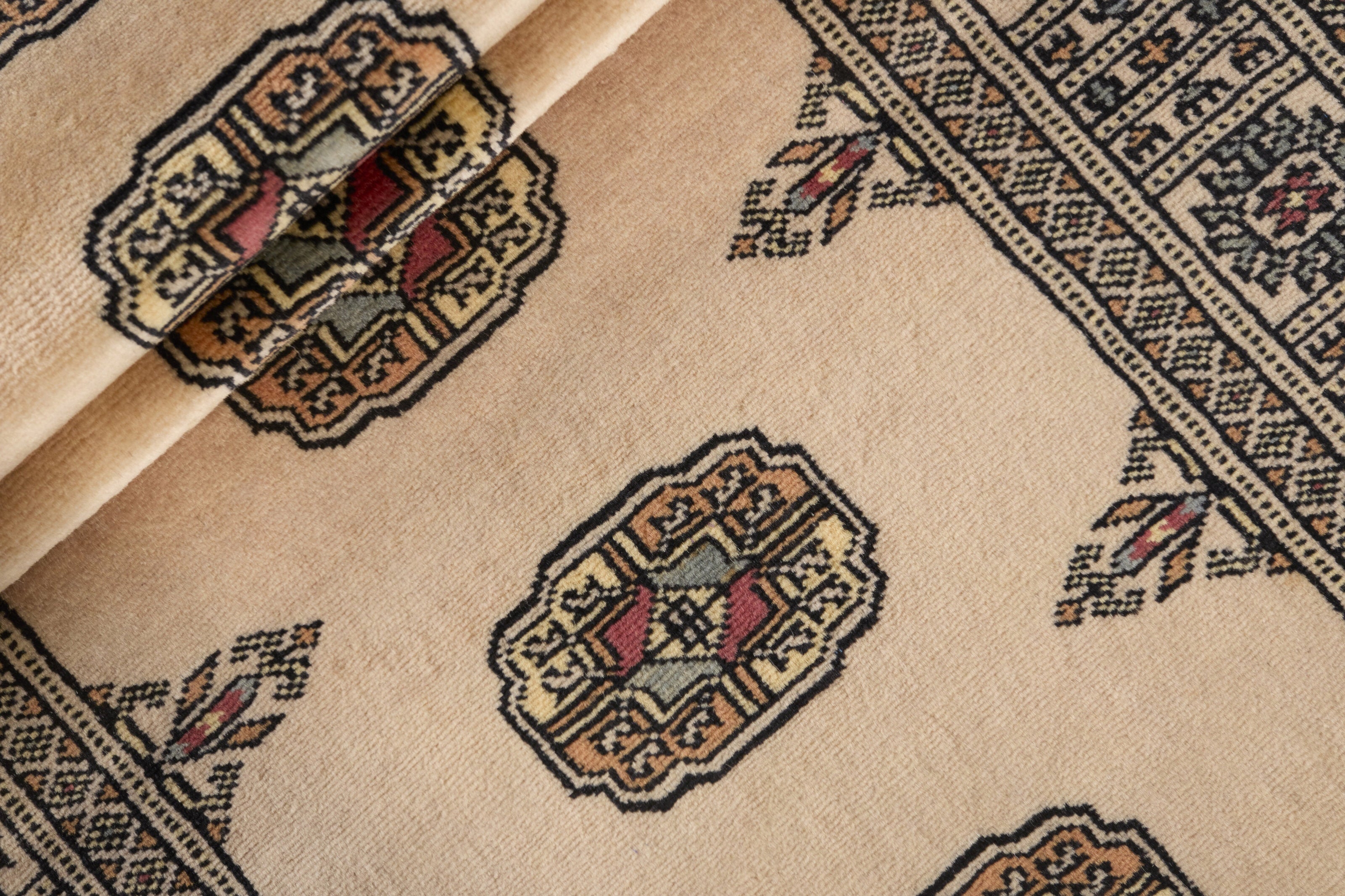 Beige Oriental runner with traditional bordered pattern