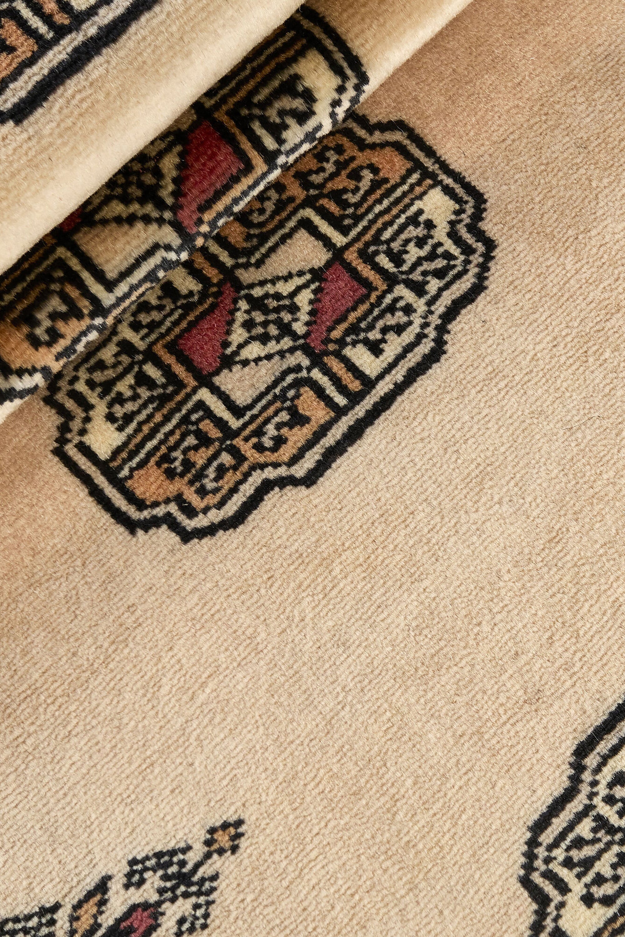 Beige Oriental runner with traditional bordered pattern