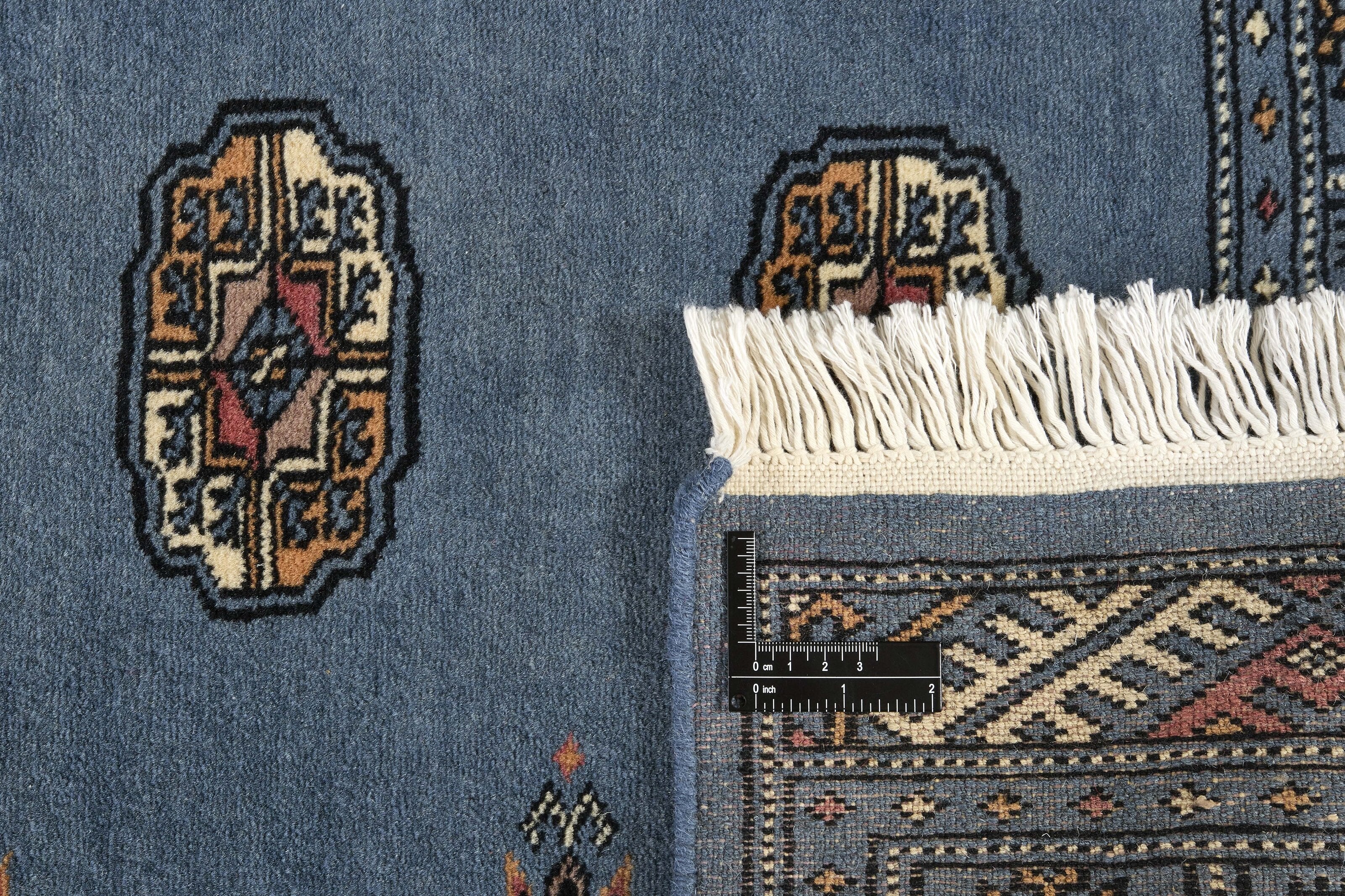 Blue Oriental runner with traditional bordered pattern