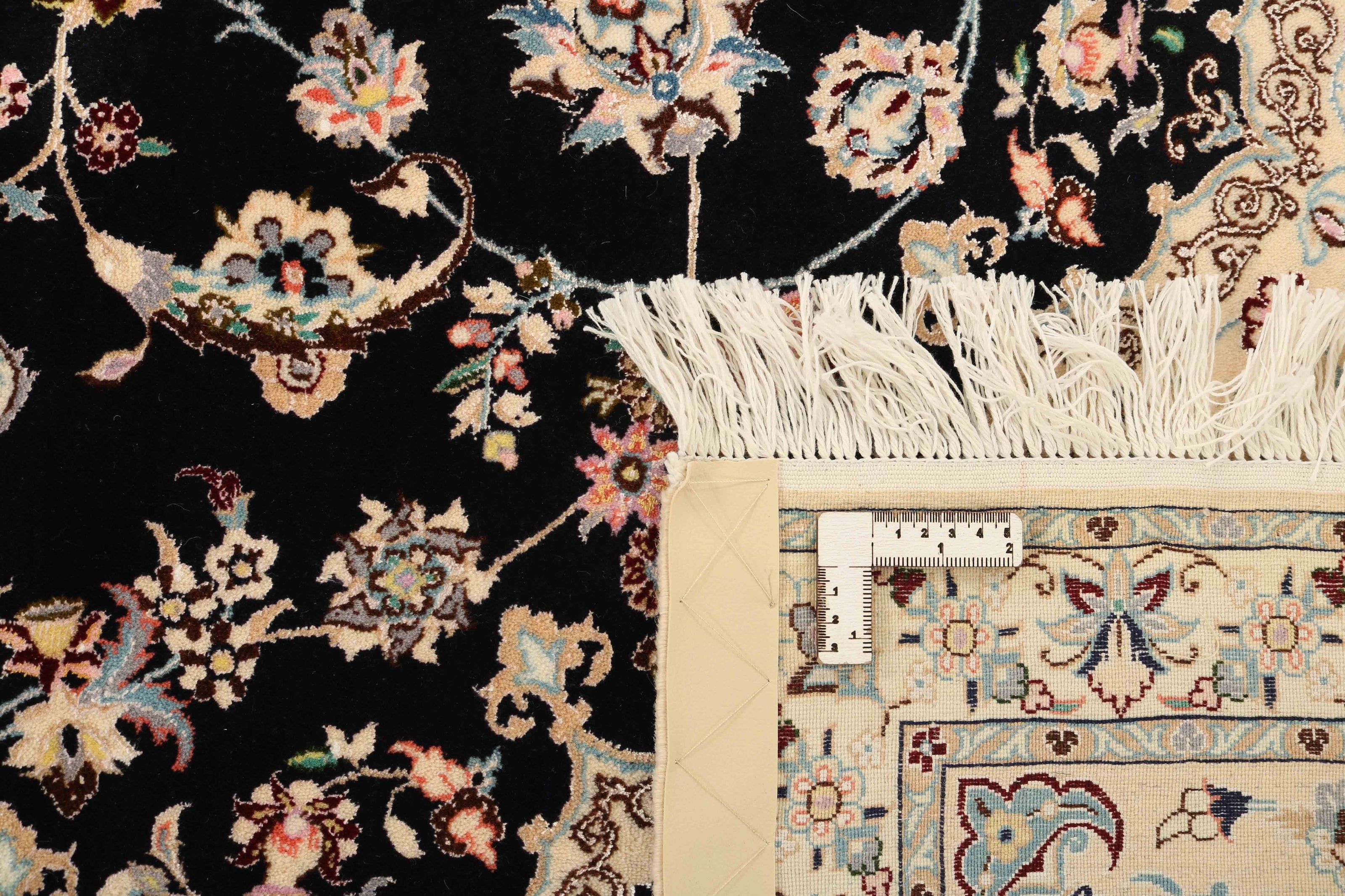 Authentic oriental rug with traditional floral design in cream, navy, blue and pink