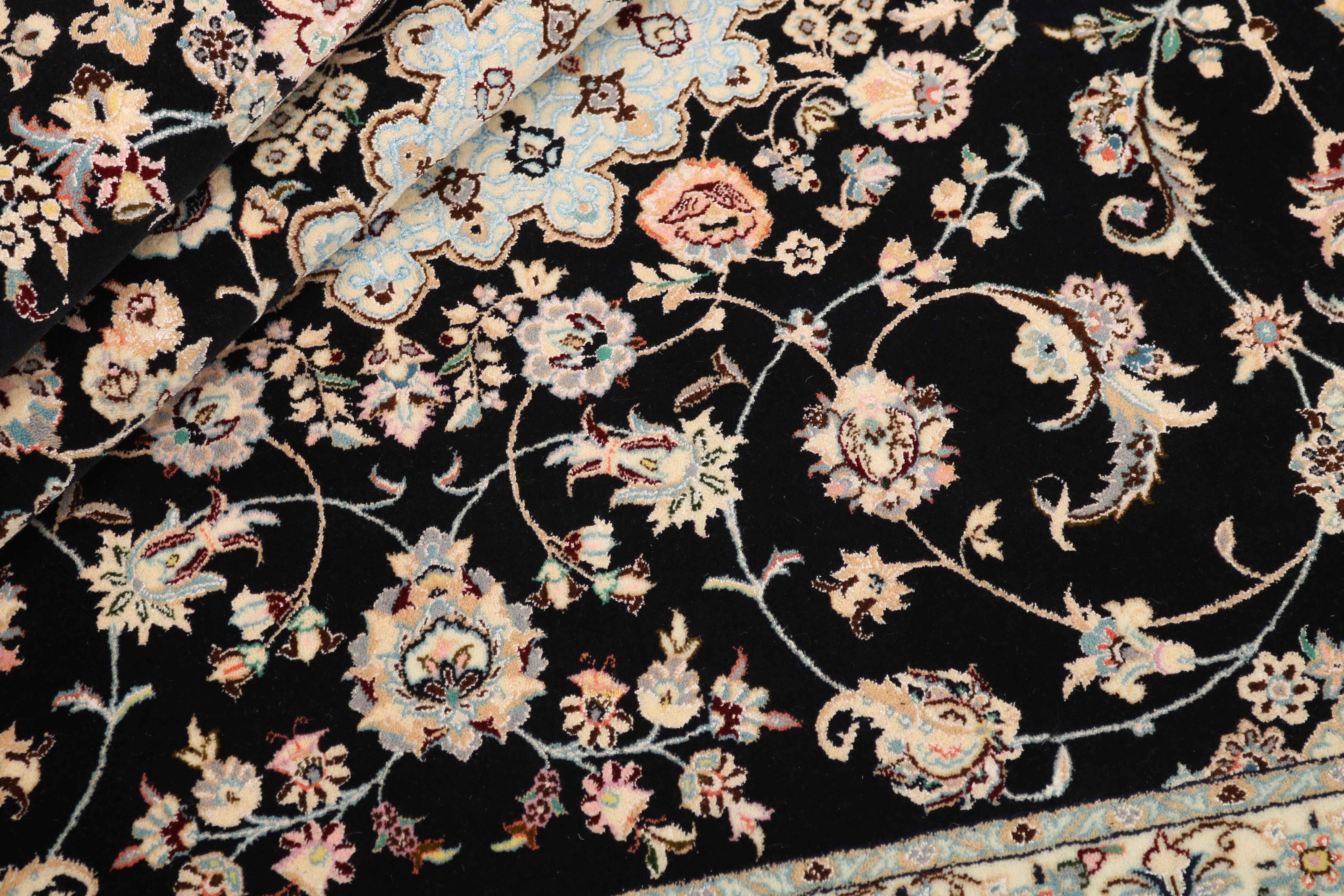 Authentic oriental rug with traditional floral design in cream, navy, blue and pink