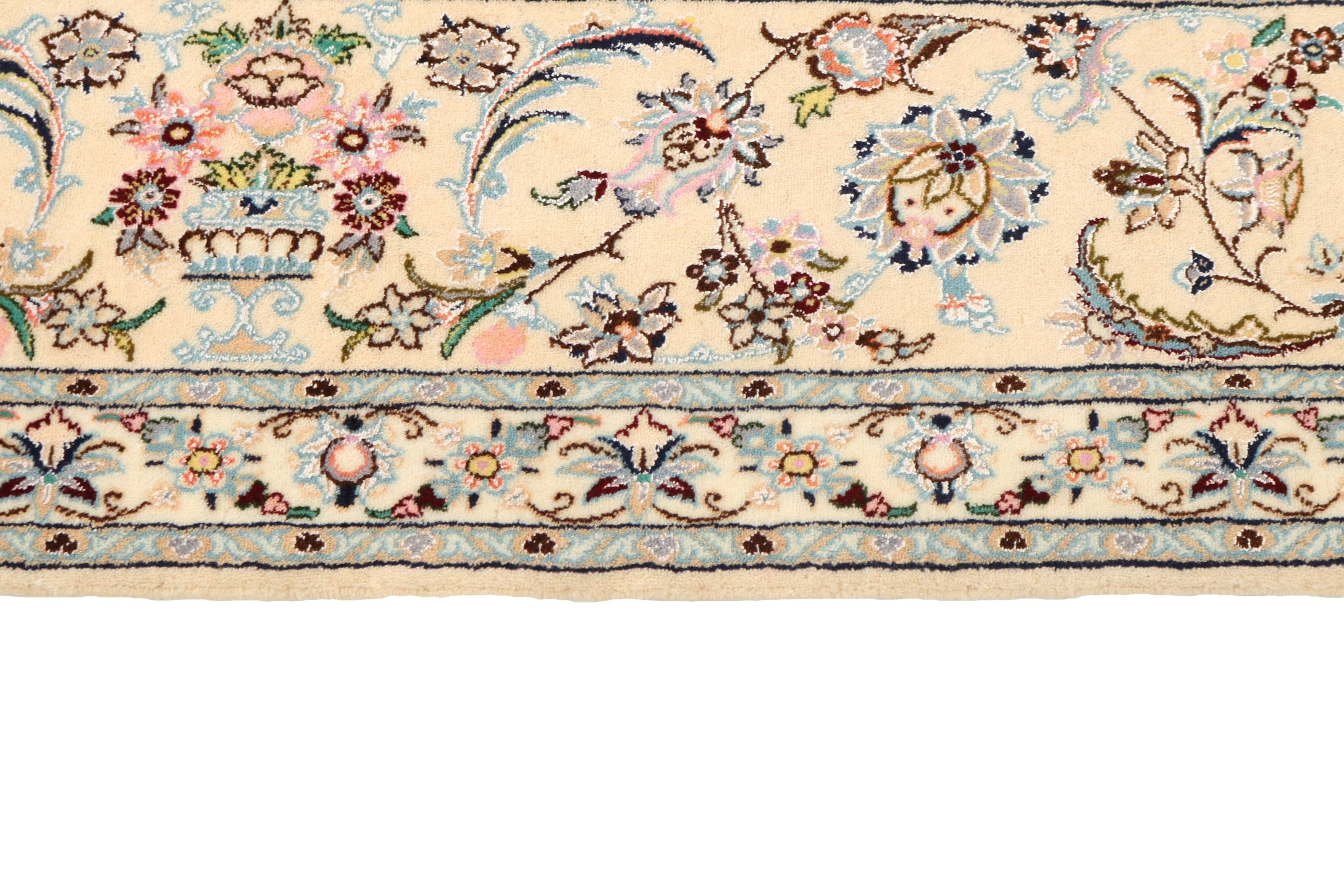 Authentic oriental rug with traditional floral design in cream, navy, blue and pink