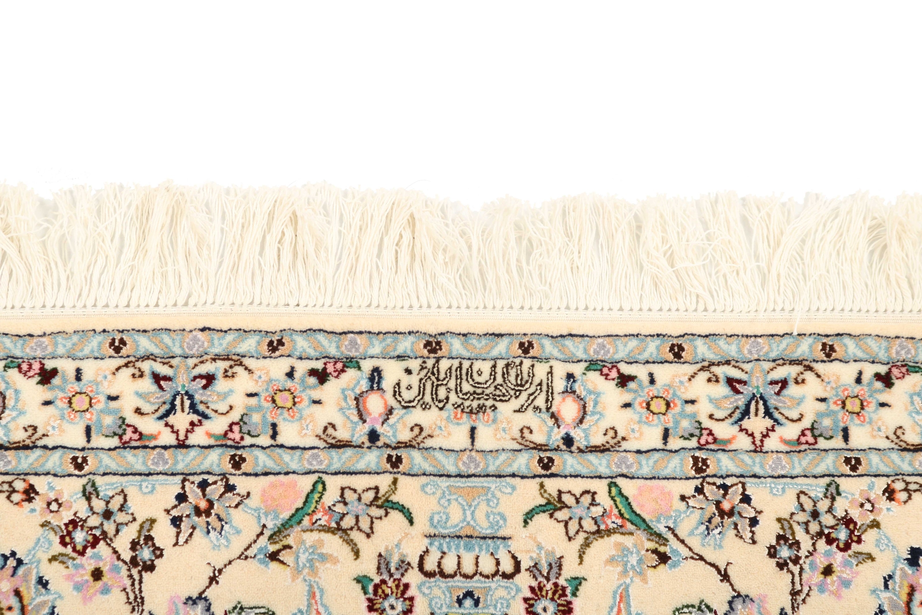 Authentic oriental rug with traditional floral design in cream, navy, blue and pink