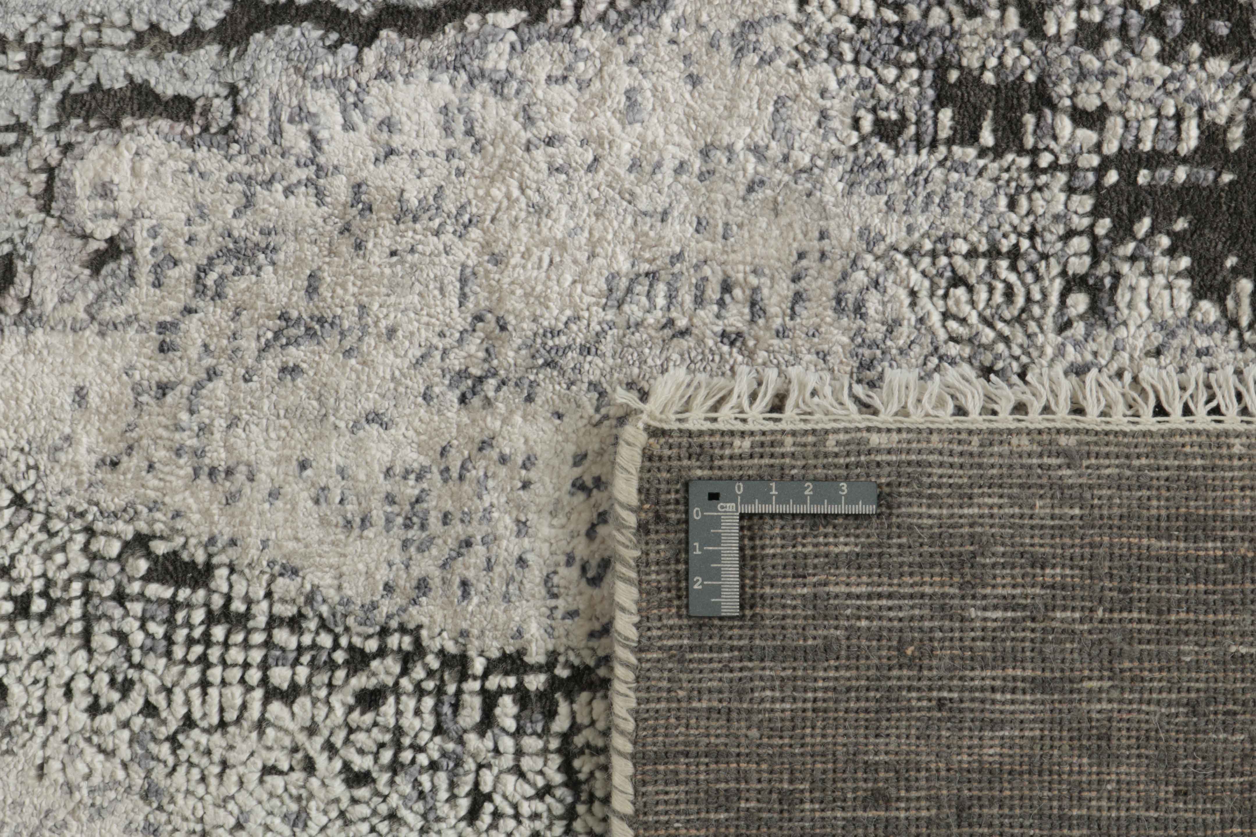 Large area rug with abstract design in grey and charcoal