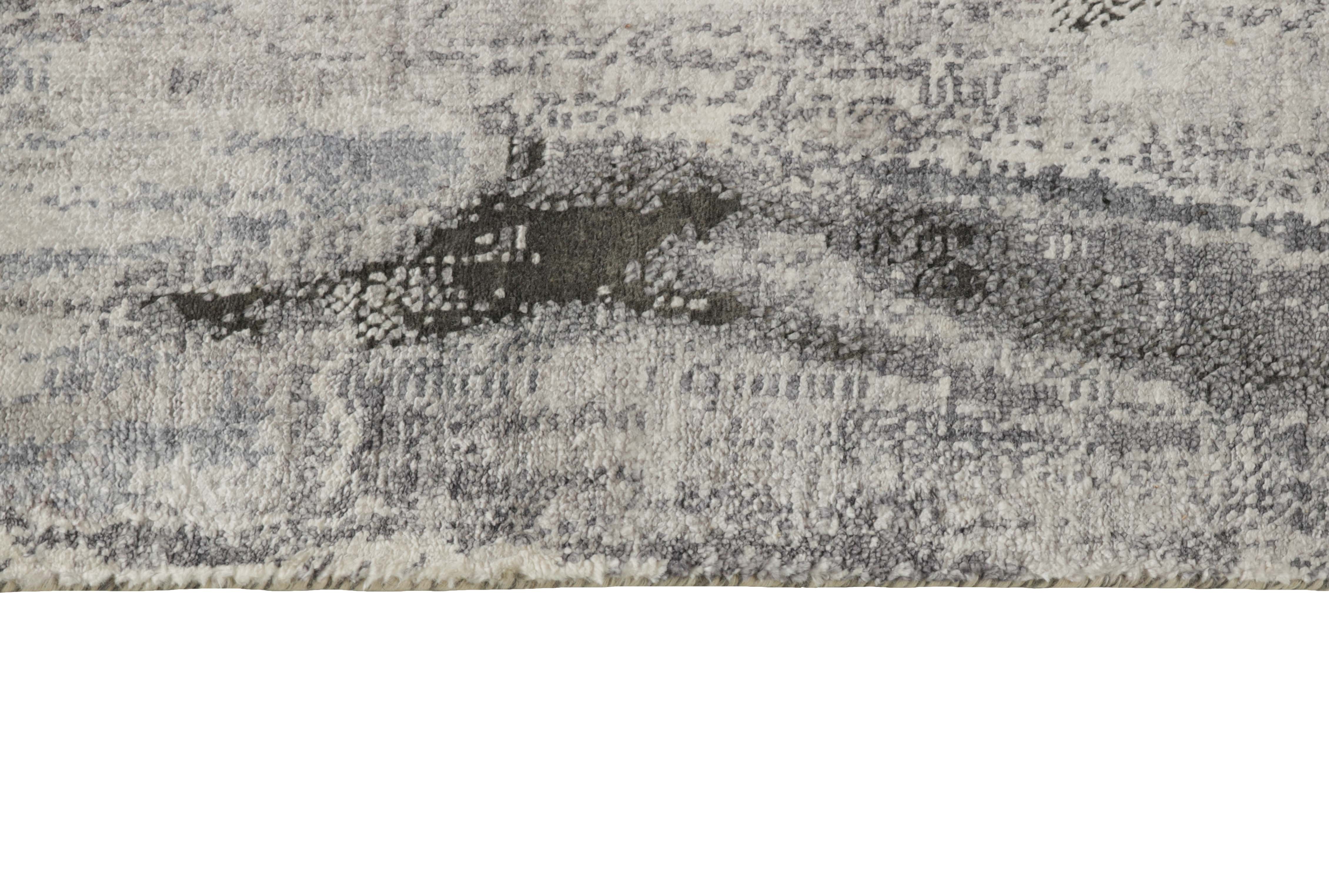 Large area rug with abstract design in grey and charcoal
