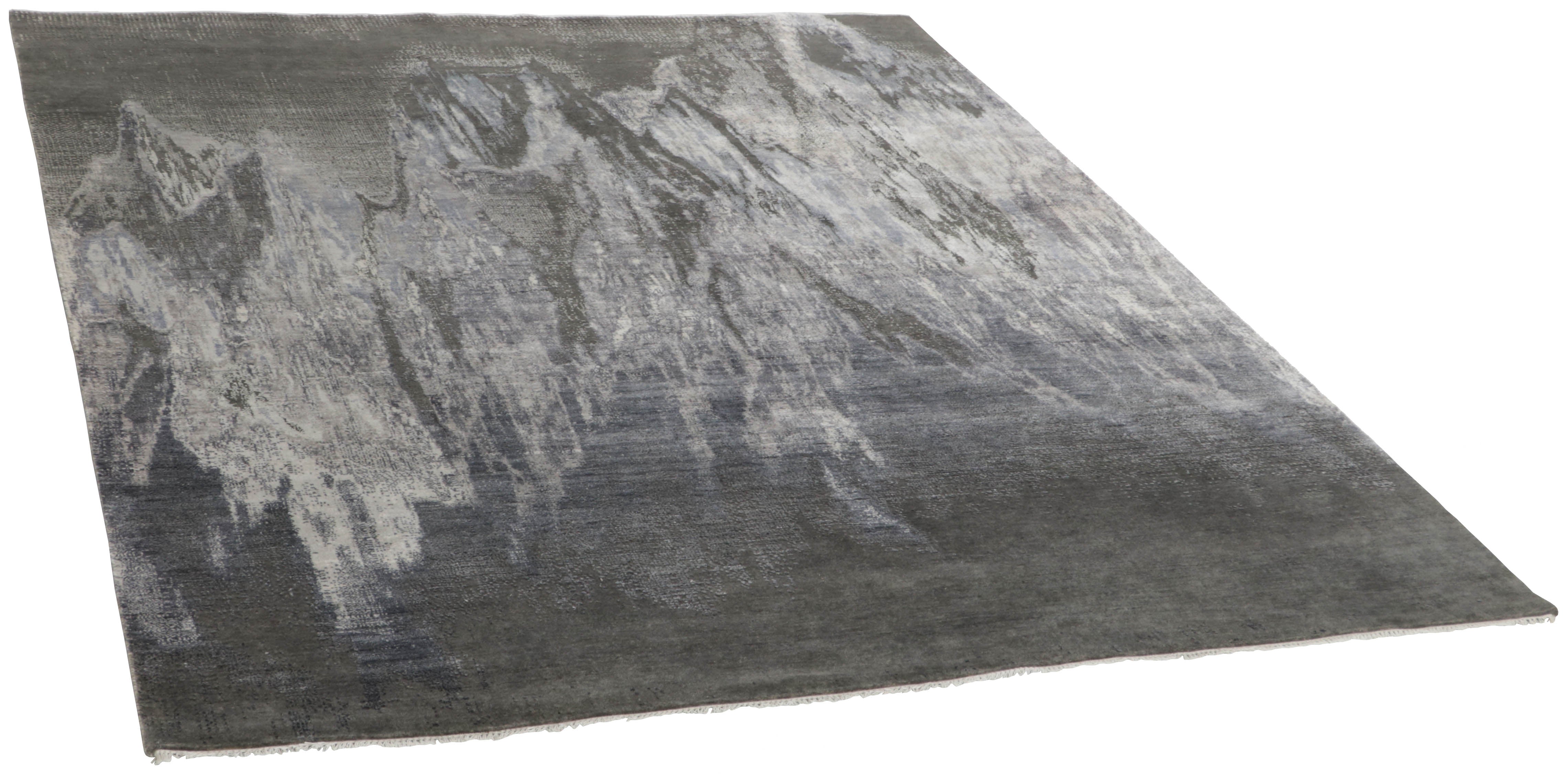 Large area rug with abstract design in grey and charcoal