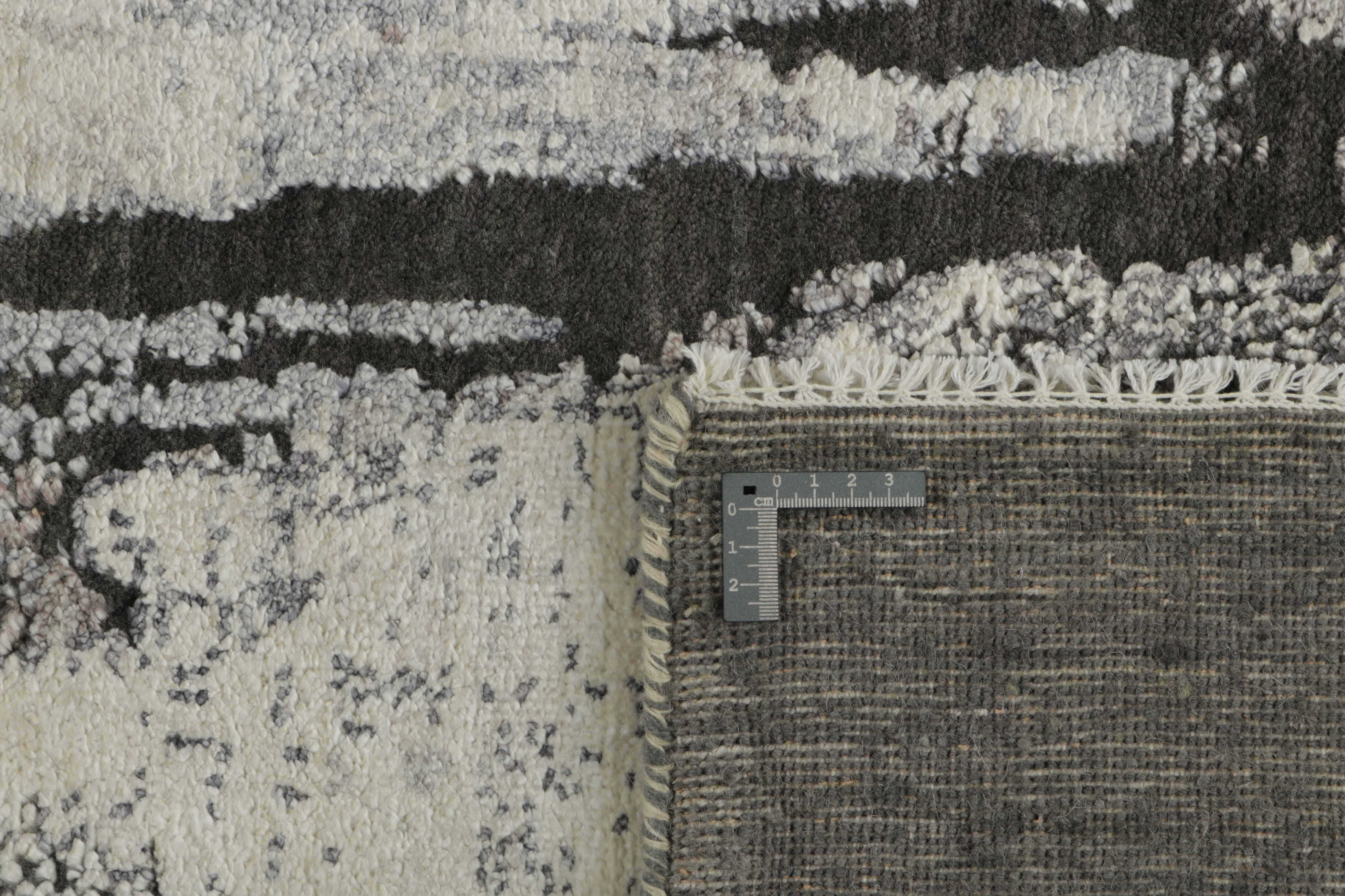 Large area rug with abstract design in grey and taupe