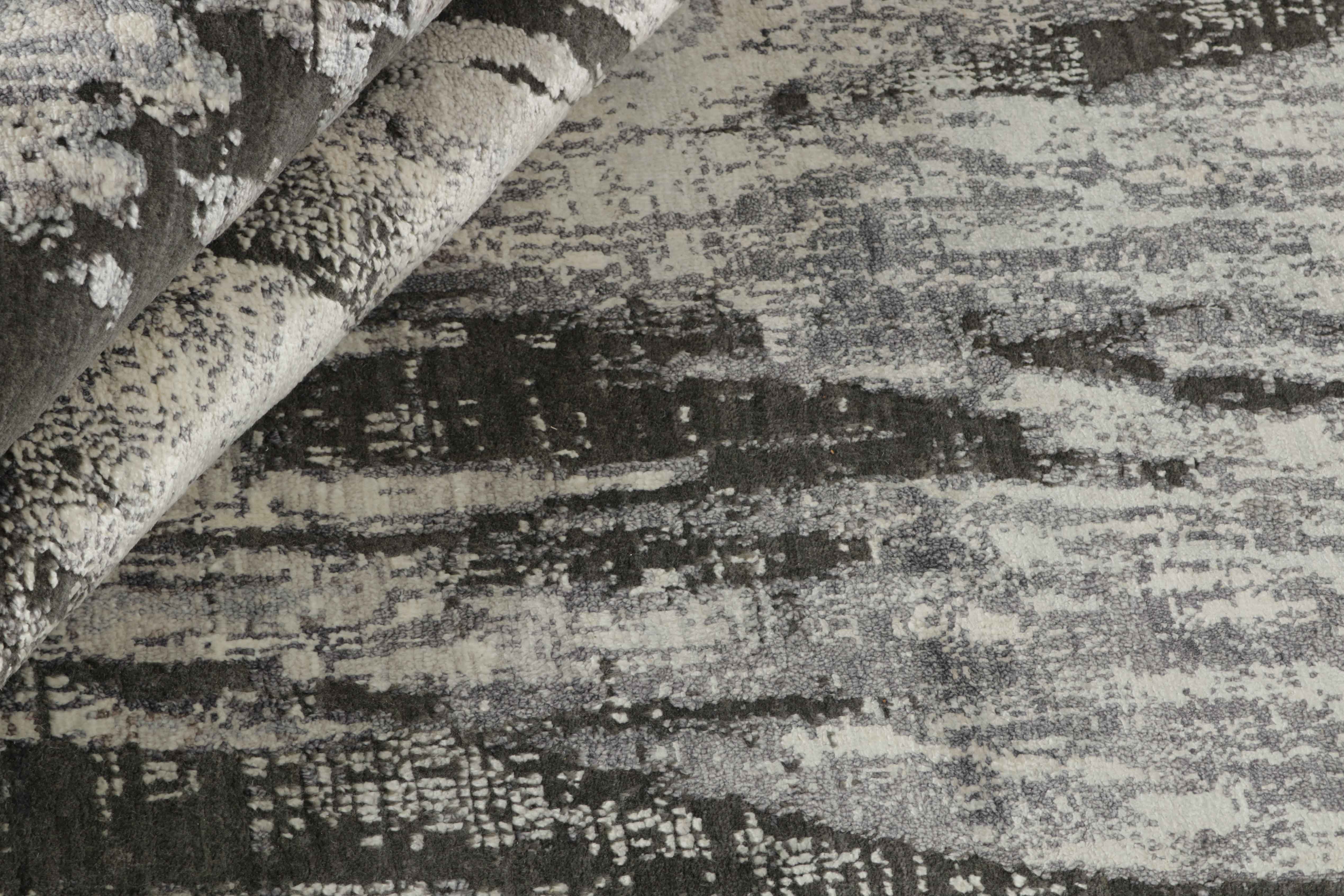 Large area rug with abstract design in grey and taupe