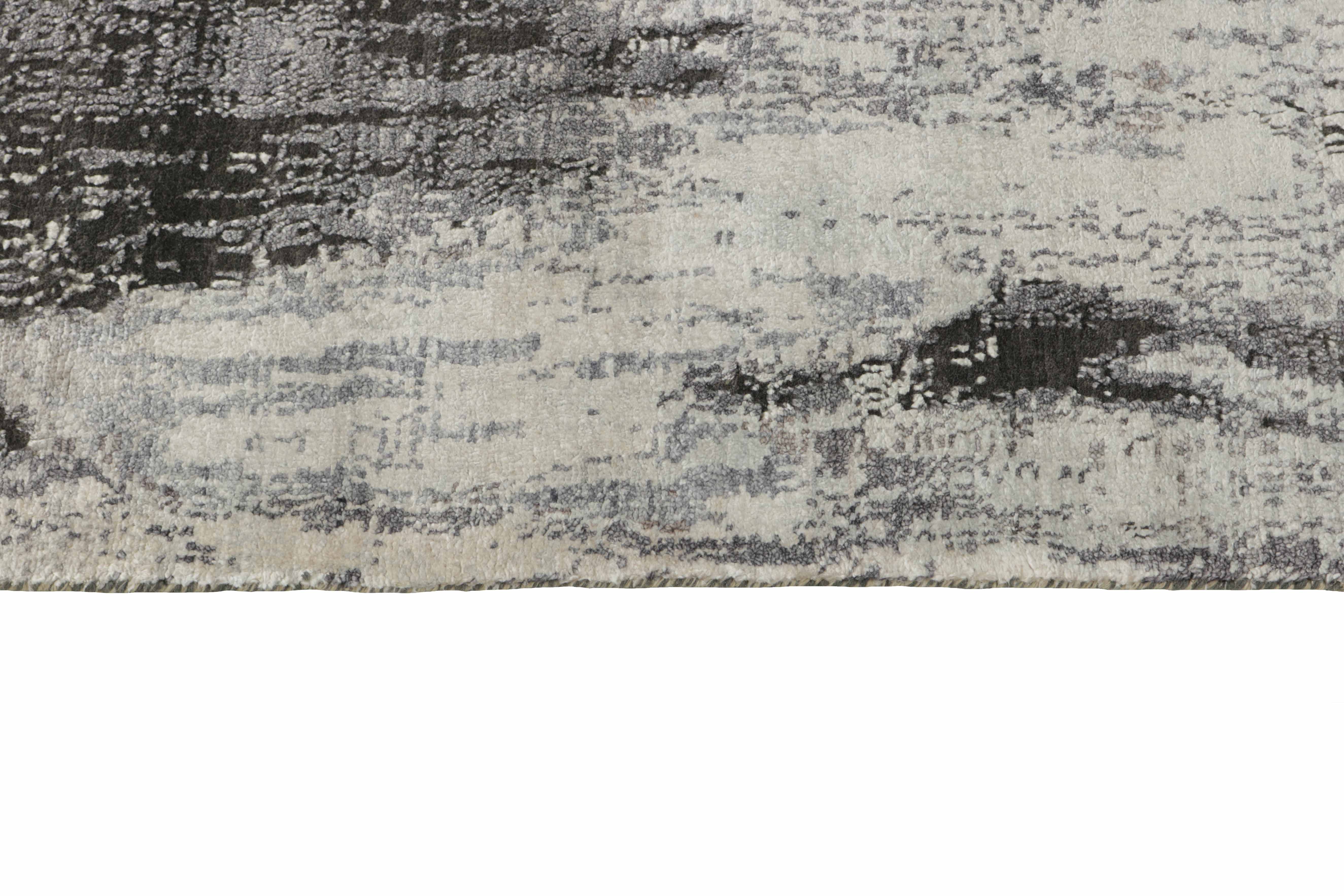 Large area rug with abstract design in grey and taupe