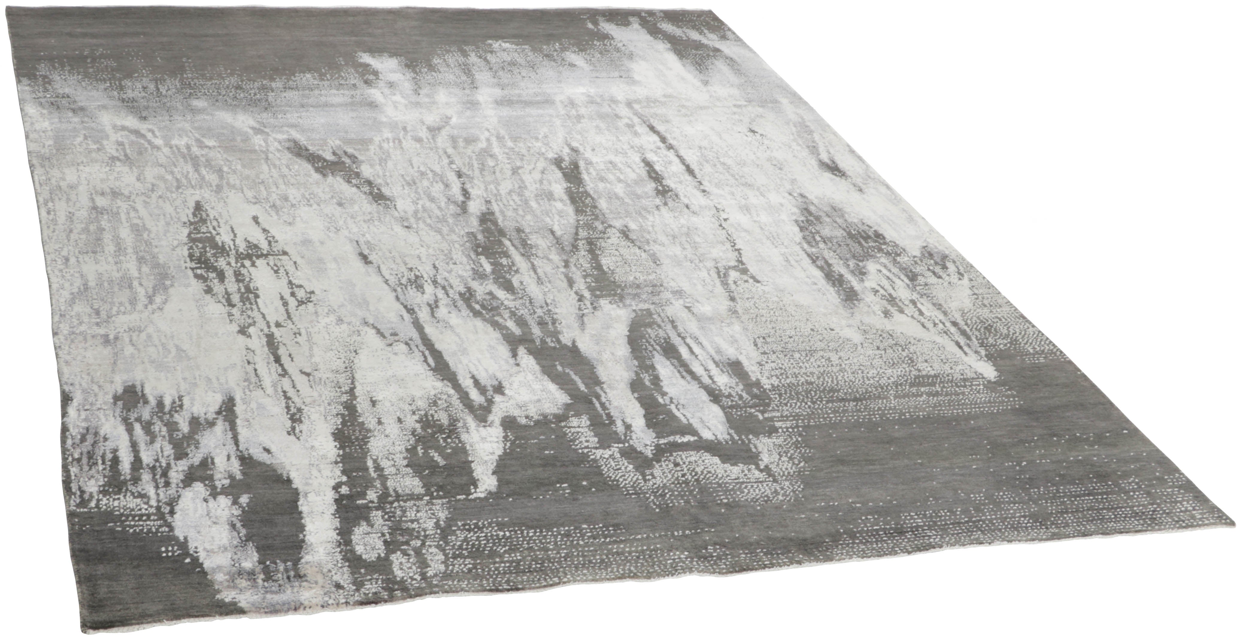 Large area rug with abstract design in grey and taupe