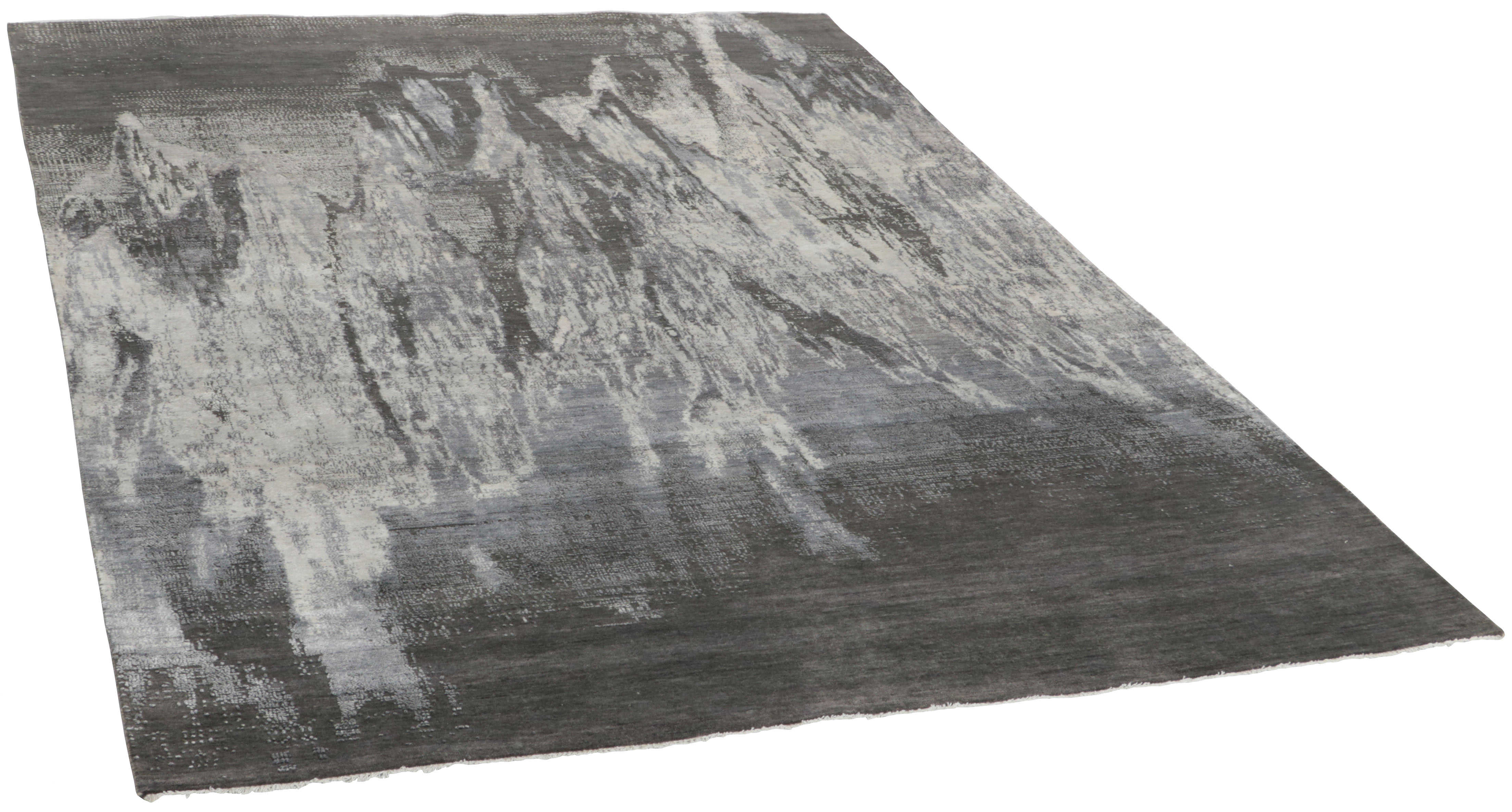 Large area rug with abstract design in grey and taupe