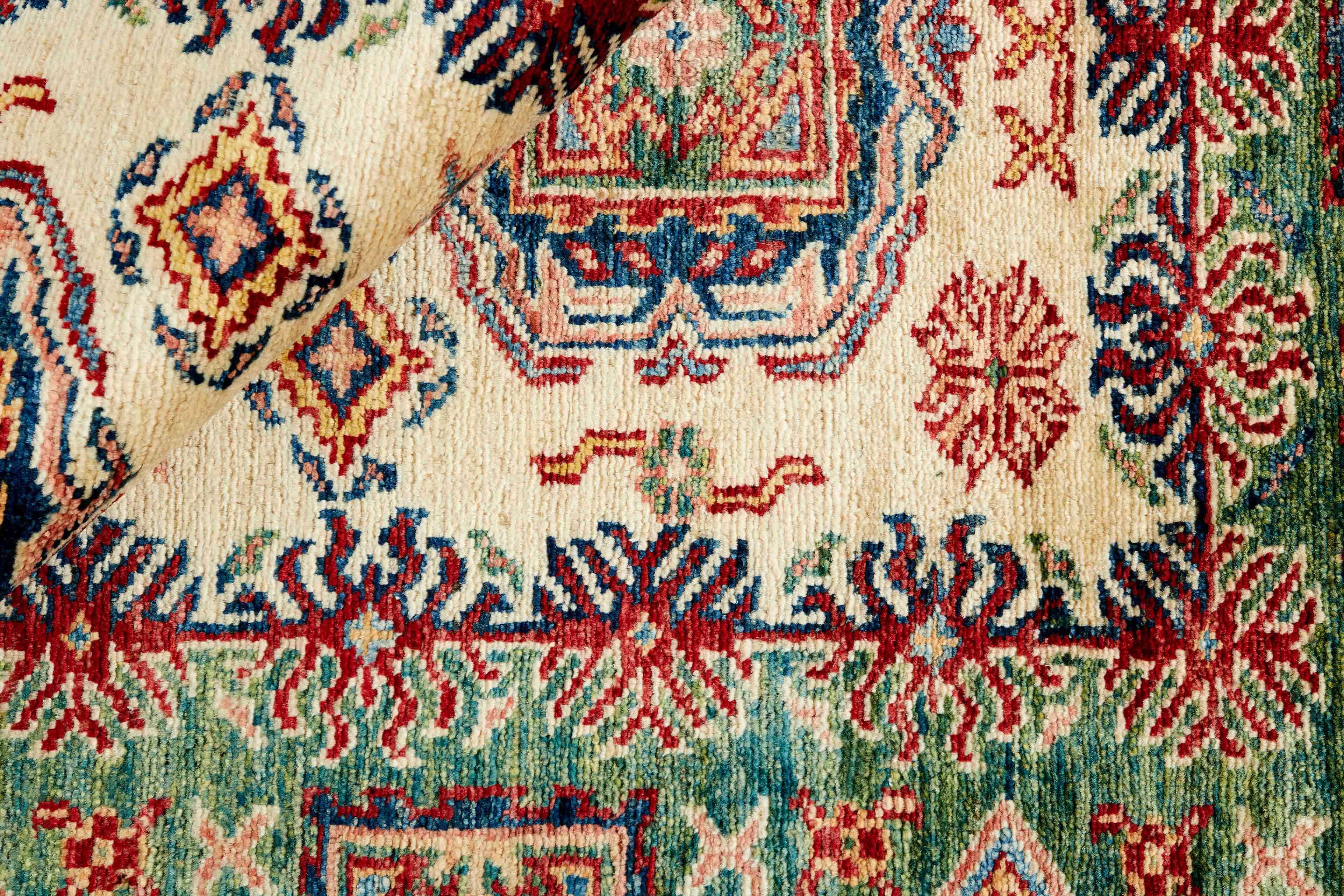 Authentic oriental rug with green and black traditional geometric design