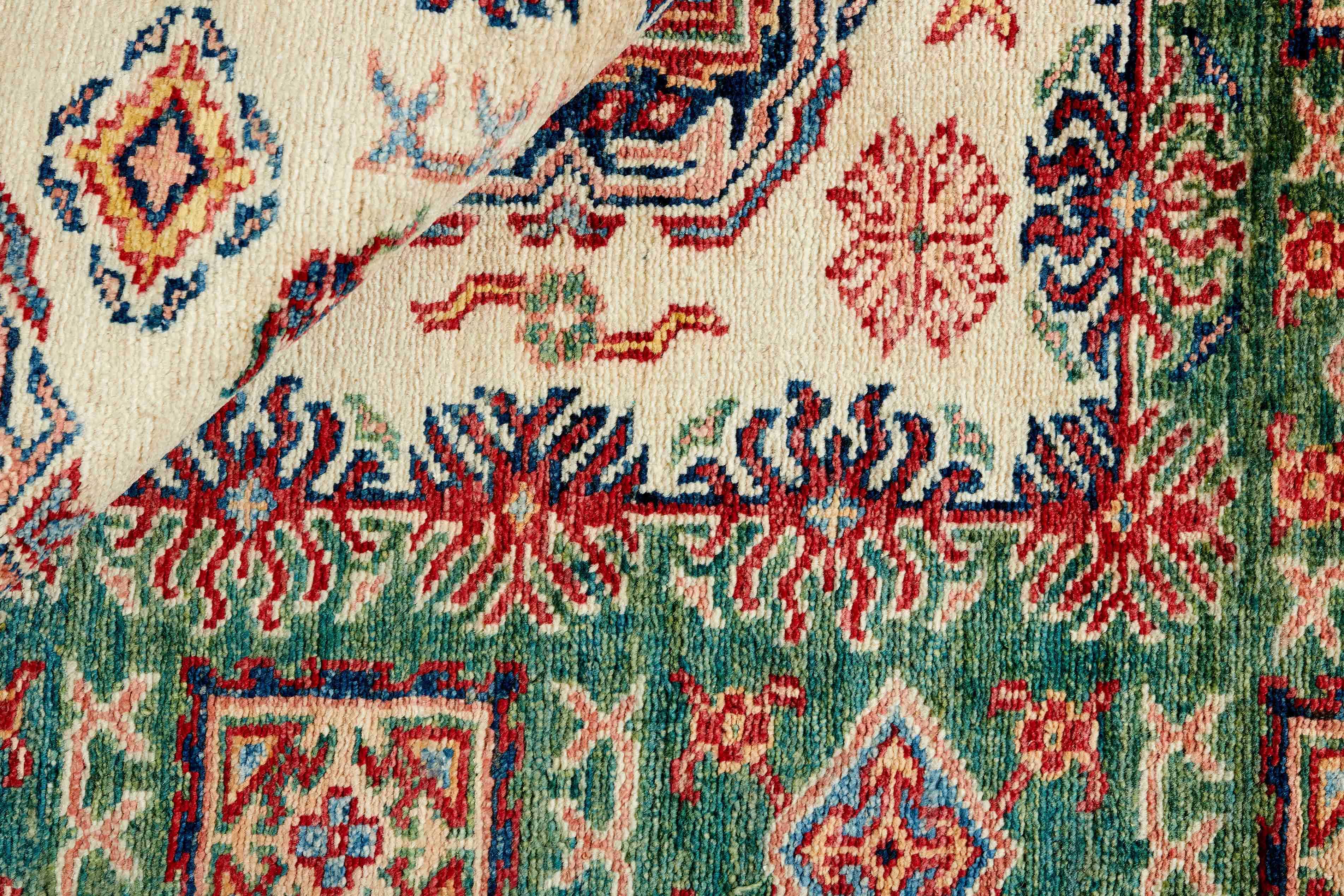 Authentic oriental rug with green and black traditional geometric design