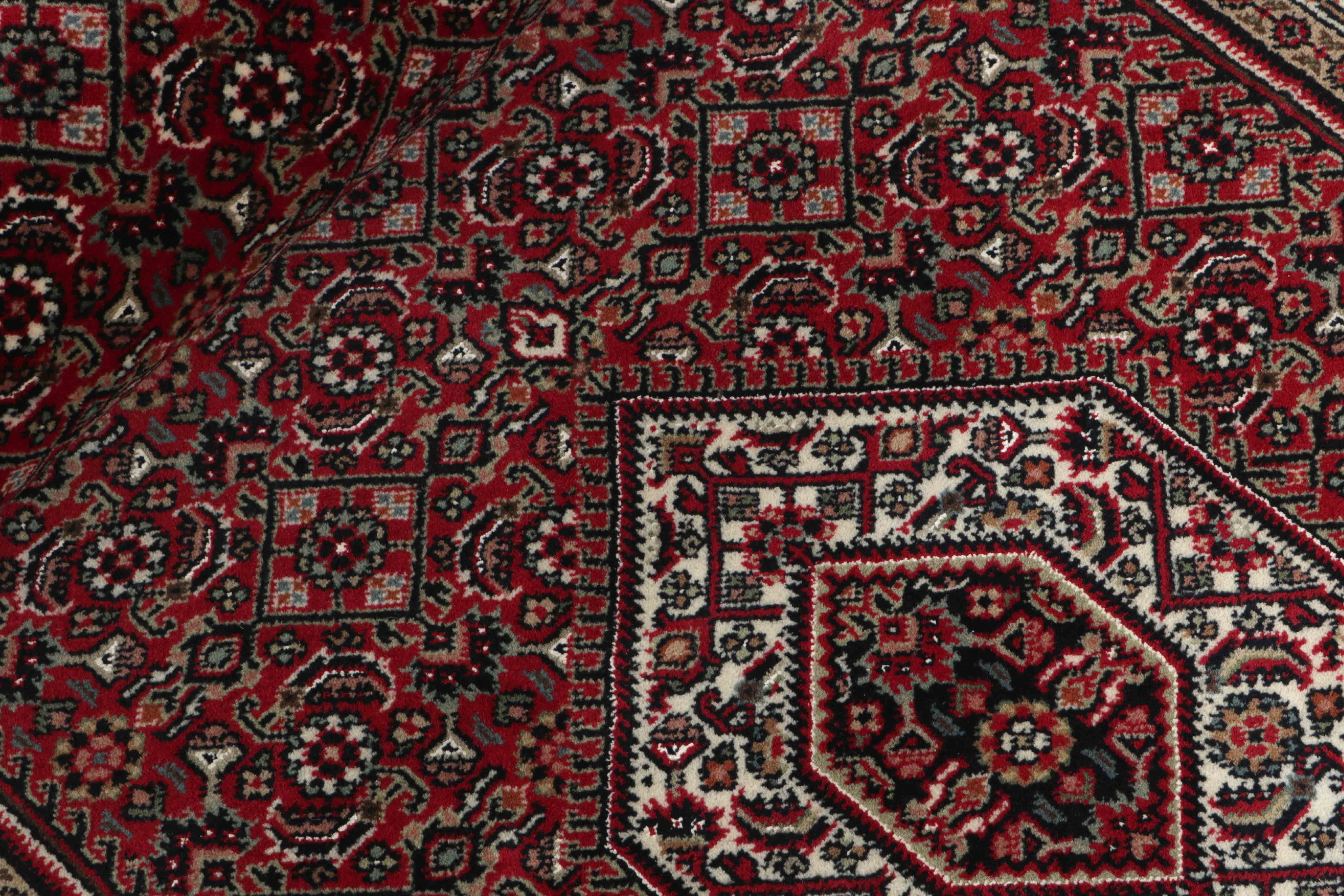 Authentic oriental rug with central medallion and traditional motifs in red