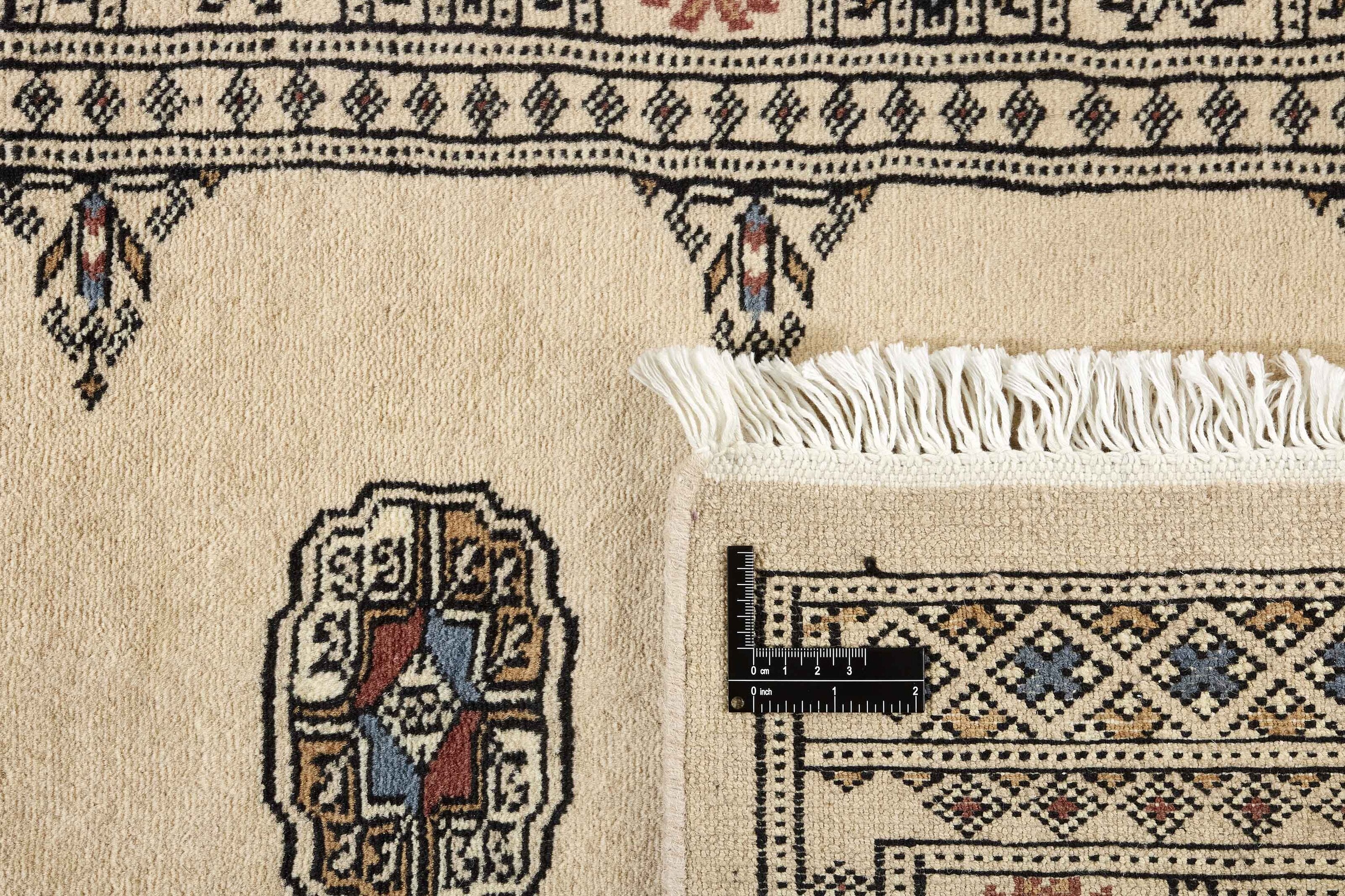 Beige Oriental runner with traditional bordered pattern